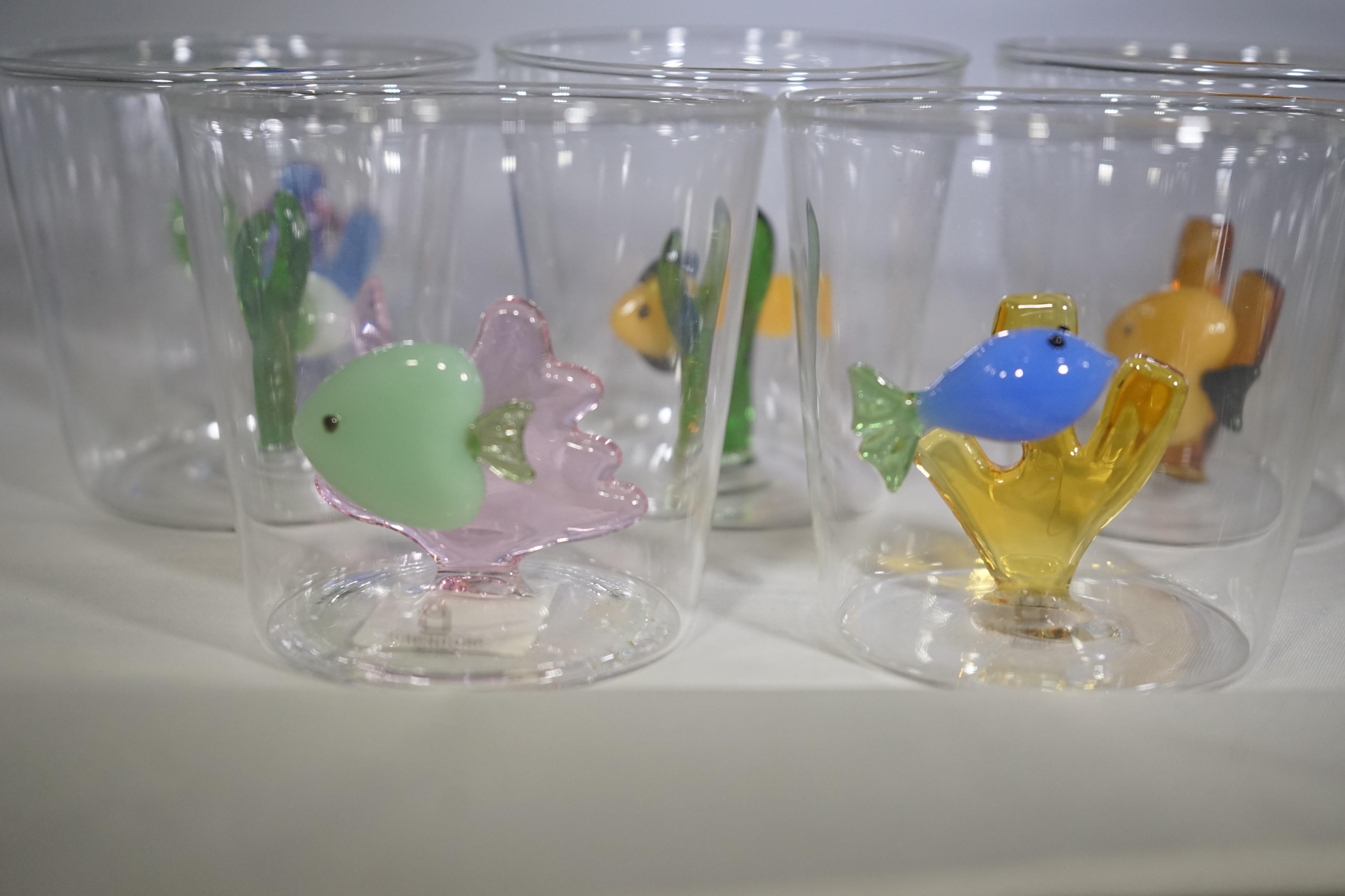 Contemporary set of six glassware tumblers with multi-color blown glass fish detailing in the glass.