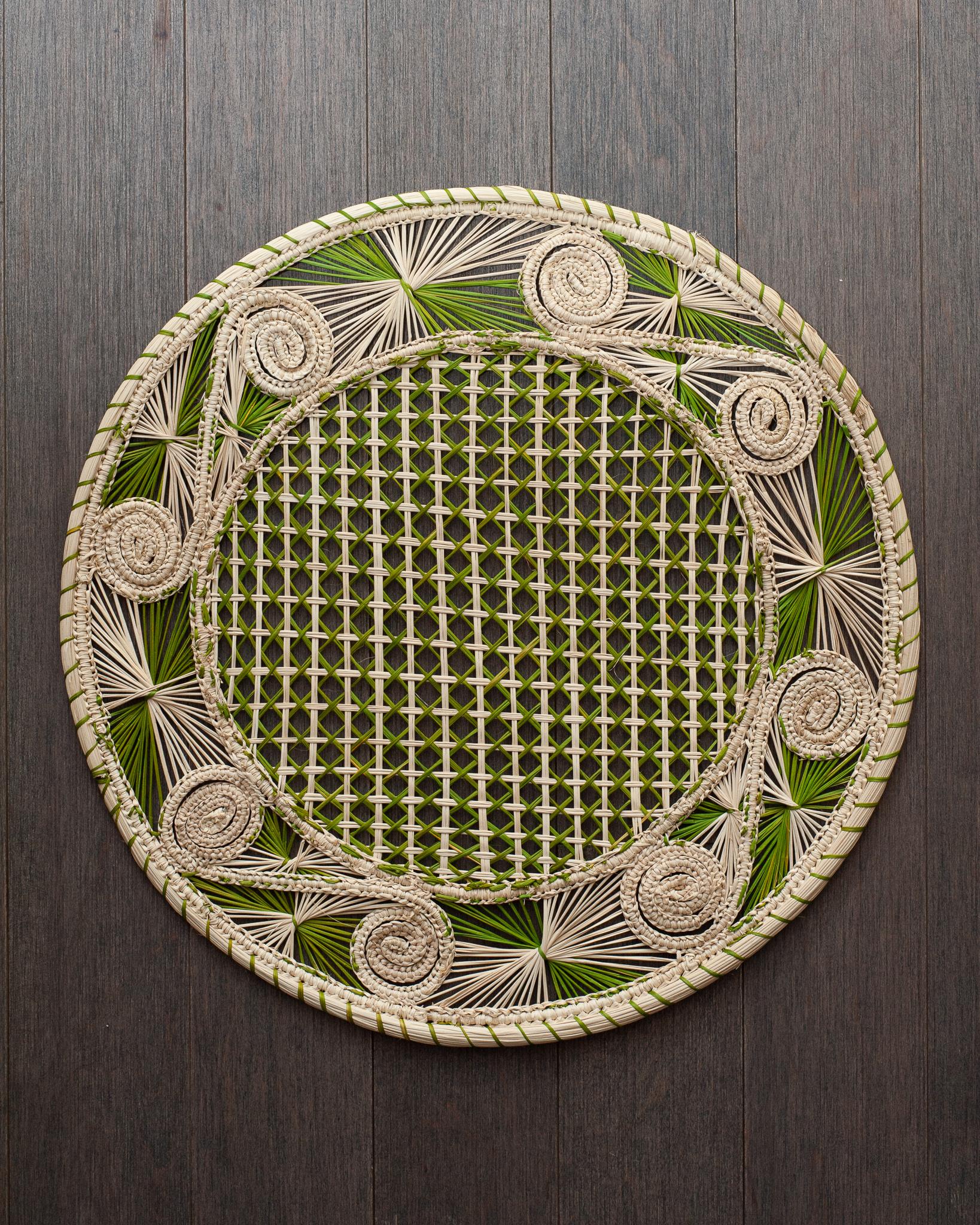 Uplift your table with these stunning handwoven rattan placemats in natural and green rattan. Finely crafted by expert artisans, these pieces all showcase the classical technique of weaving in a modern way. From Jean Michel Frank to the House of
