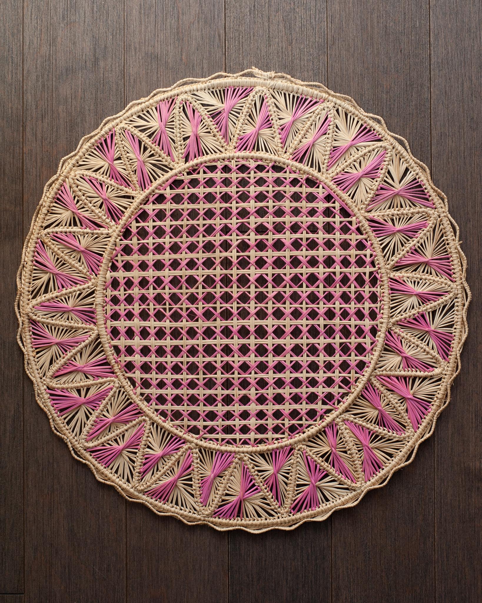 Uplift your table with these stunning handwoven rattan placemats in natural and pink rattan. Finely crafted by expert artisans, these pieces all showcase the classical technique of weaving in a modern way. From Jean Michel Frank to the House of