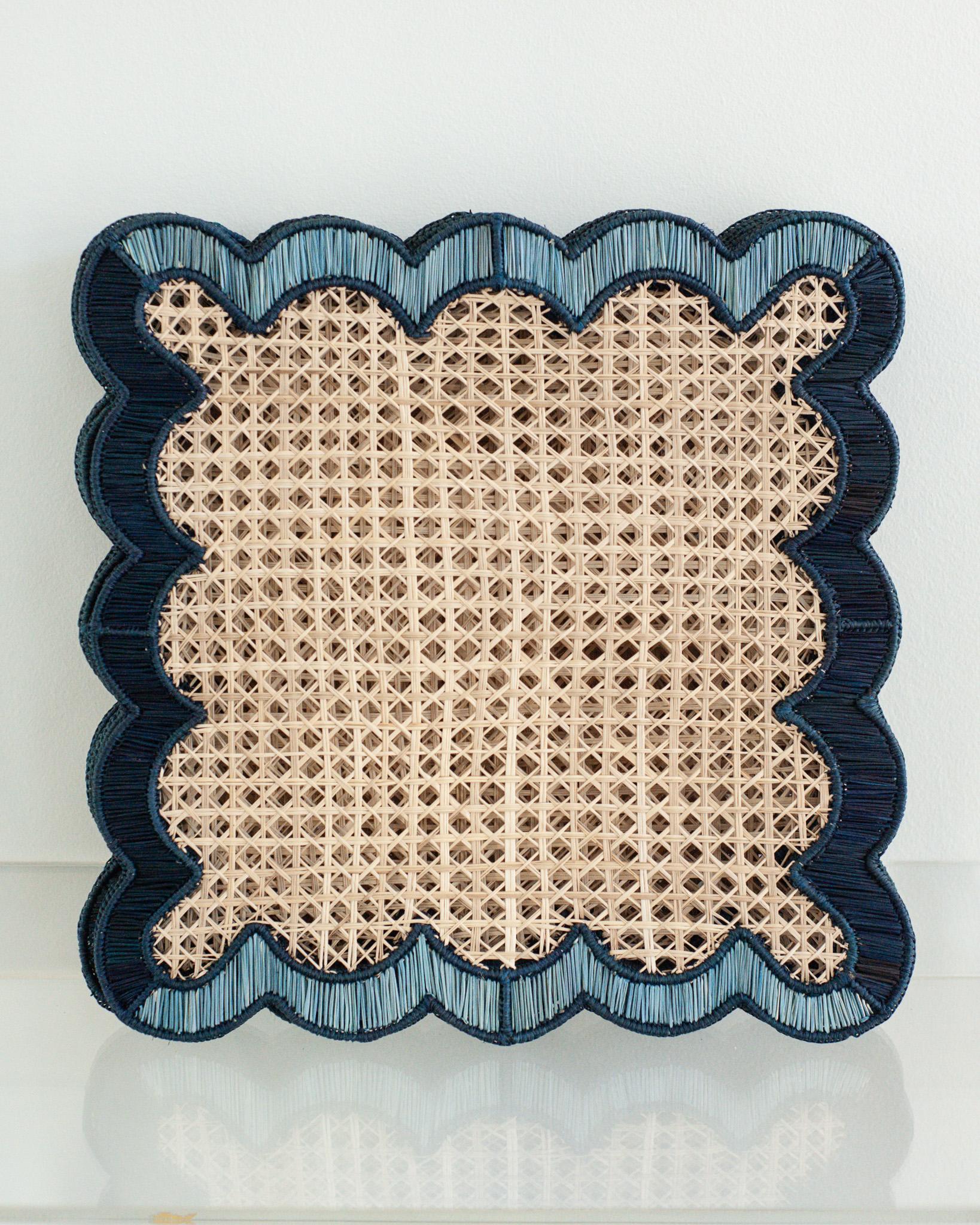 Uplift your table with these stunning handwoven rattan waves placemats in natural, navy and sky blue. Finely crafted by expert artisans, these pieces all showcase the classical technique of weaving in a modern way. From Jean Michel Frank to the