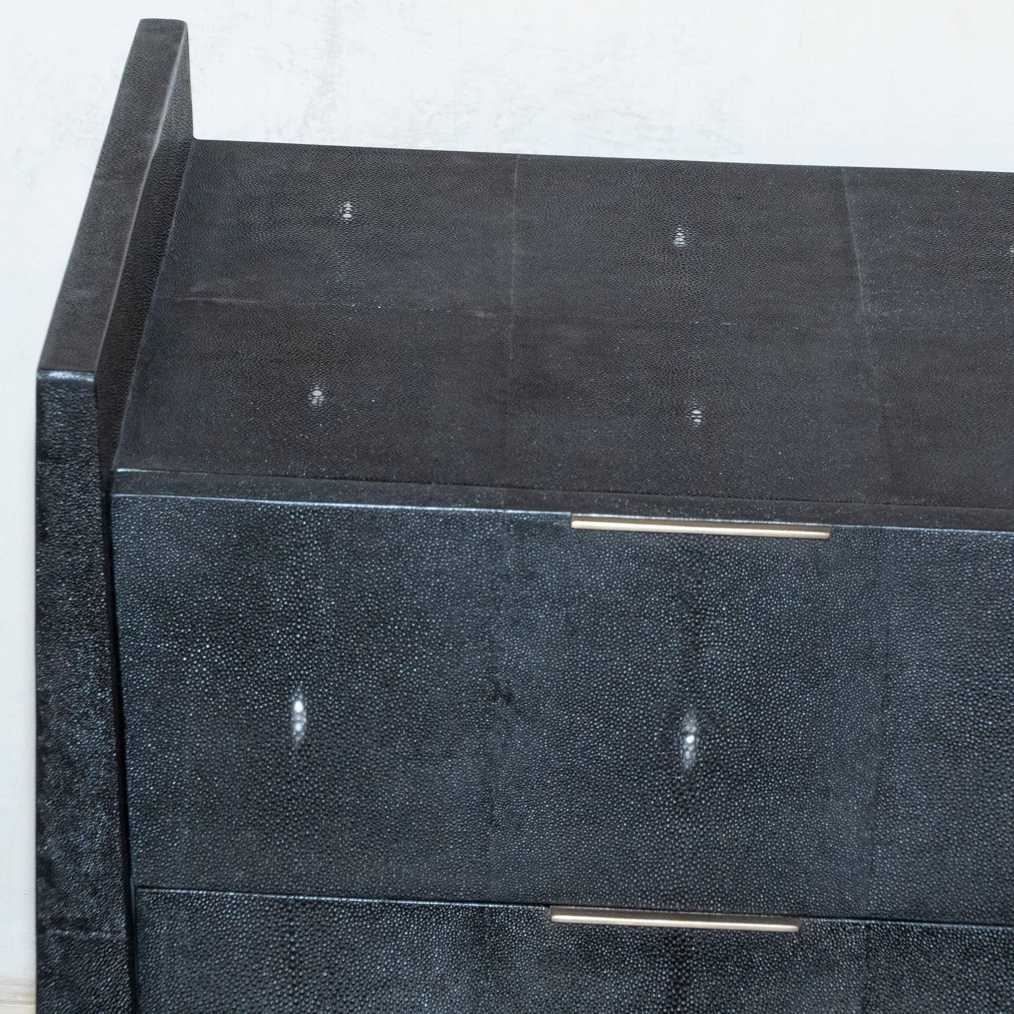 Contemporary three-drawer dresser covered in ink black shagreen, bronze details, France.