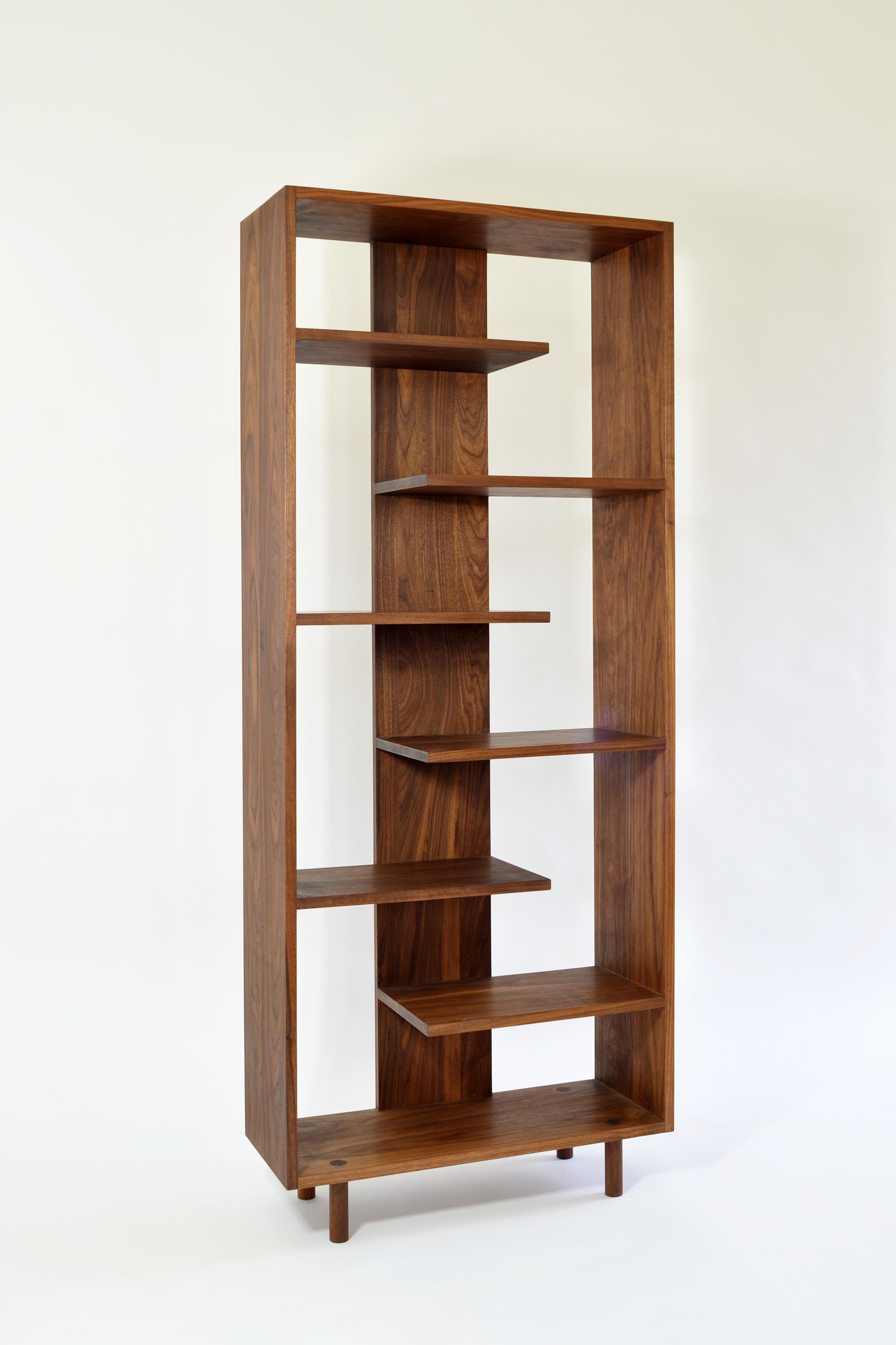 Paso shelving was designed to embody simplicity and harmony through the use of rhythmical geometries and warm natural materials. Alternating ladder-like shelves create discrete sections which are ideal for displaying favorite books and objects. This