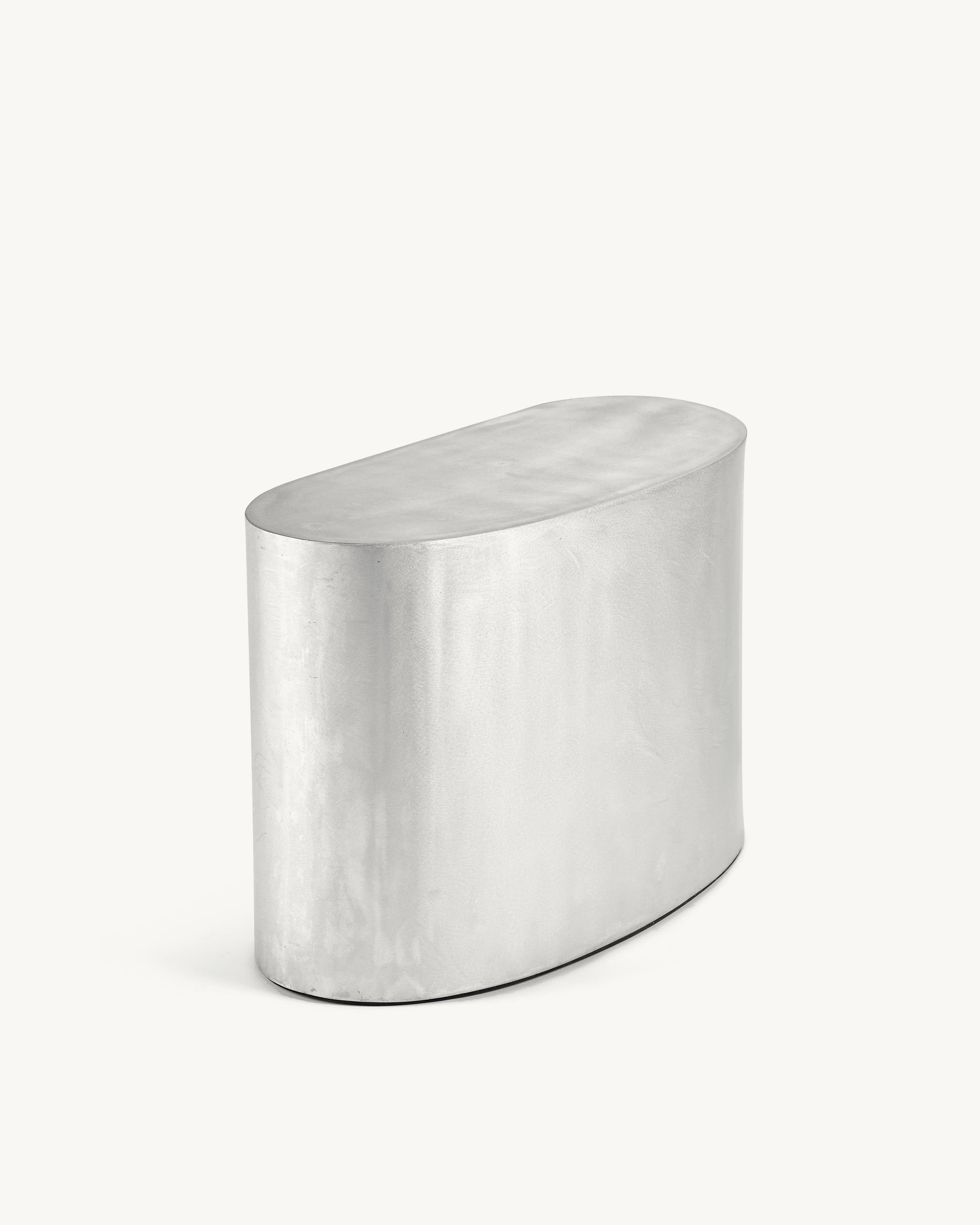 Side Table 'Assemble' by Destroyers/Builders
Finish: Aluminum
Dimensions: L 58 W 27 H 45 CM

The Assemble sofa designed by destroyers/builders encourages exactly what its name suggests: to assemble your own sofa. The asymmetrical cushions are
