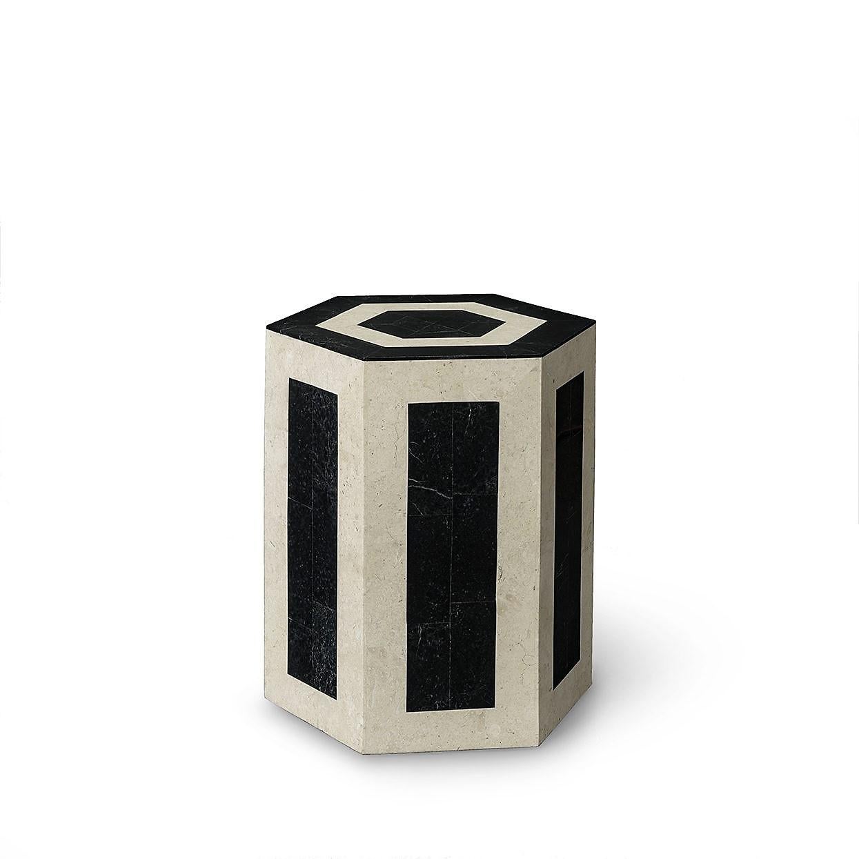 Each side table is hand-cut in black and cream natural stone and features the same pattern in opposite colors. The geometric pattern is hand-cut and inlaid over a fiberglass frame. 

The stone is a natural material and may slightly vary by color or