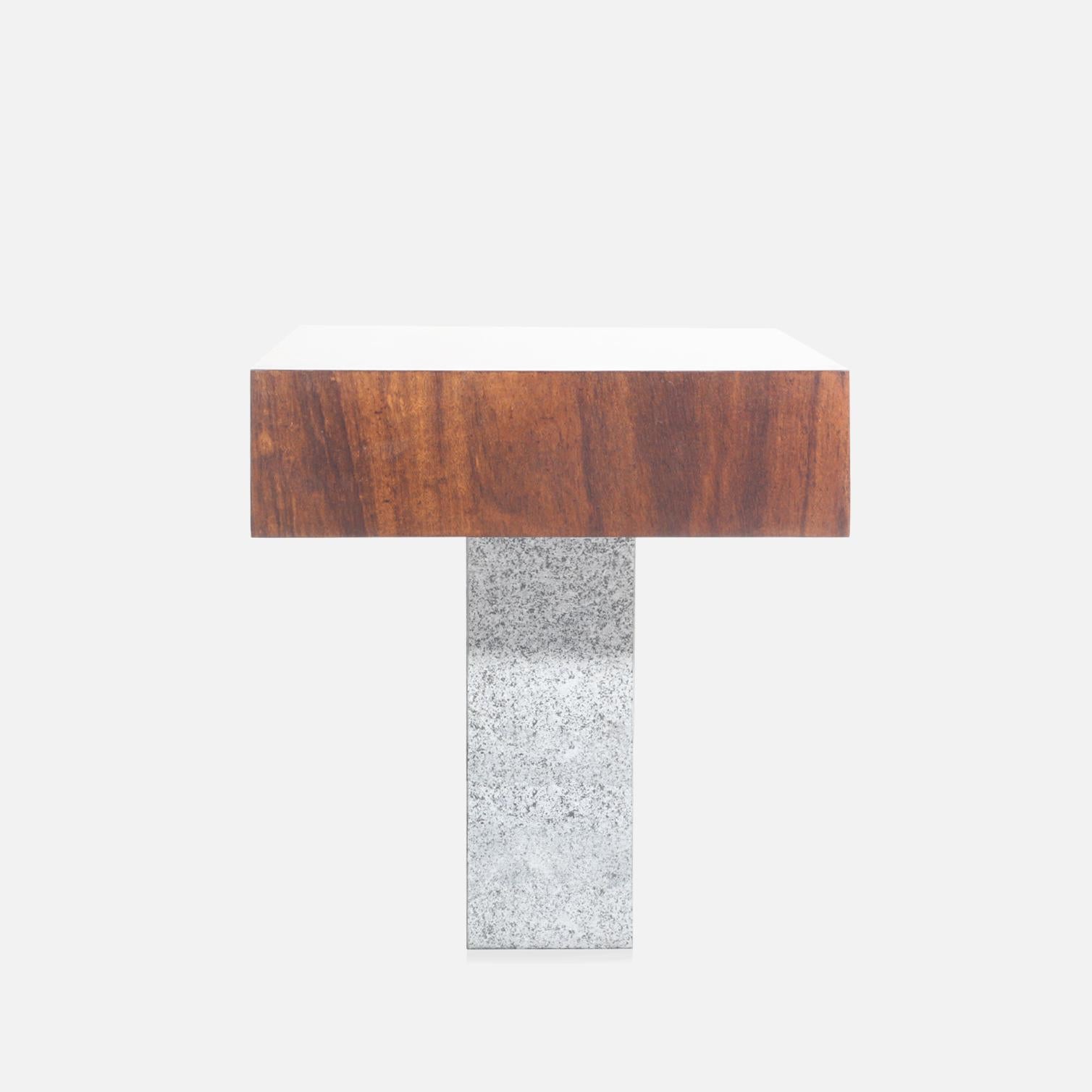 Found in the south of Brazil, Imbuia wood possesses deep, rich colors and interesting grain patterns that make every object unique. The Granite Stone base received a mechanical superficial treatment, giving a natural and quiet feeling. Designed with