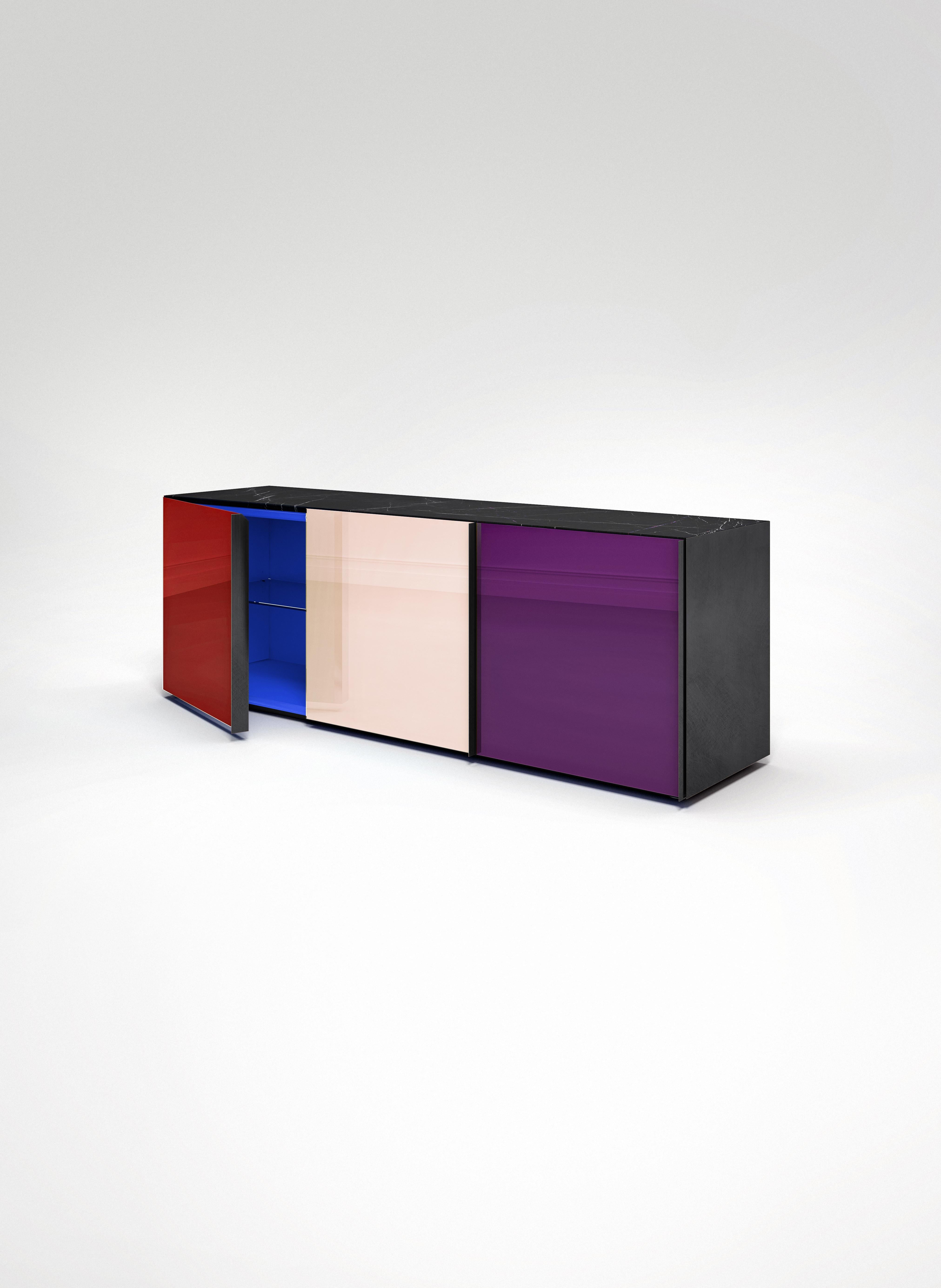 Sideboard 01
Sideboard featuring 3 back-painted glass doors colored, New Saint Laurent marble top, lacquered wooden interior, black anodized side panels and handles. Each of the three compartments has an internal glass shelf. It can be placed in any
