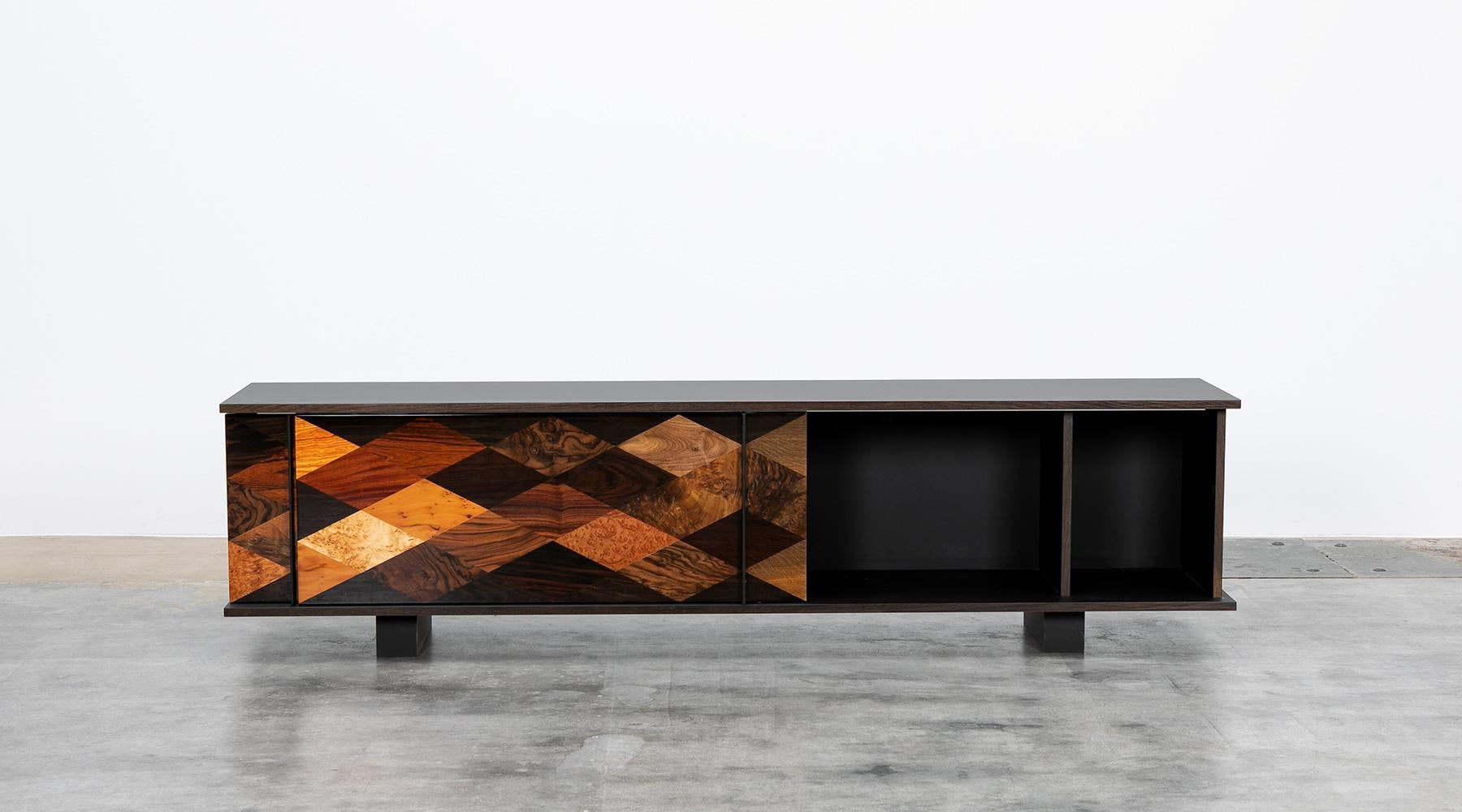 Sideboard by contemporary German artist Johannes Hock. The sliding doors of this unique piece are made of diamond shaped veneers of various origin such as maple, ebony, yew, walnut, rosewood, Makassar, poplar, oak and more. The body is made of black