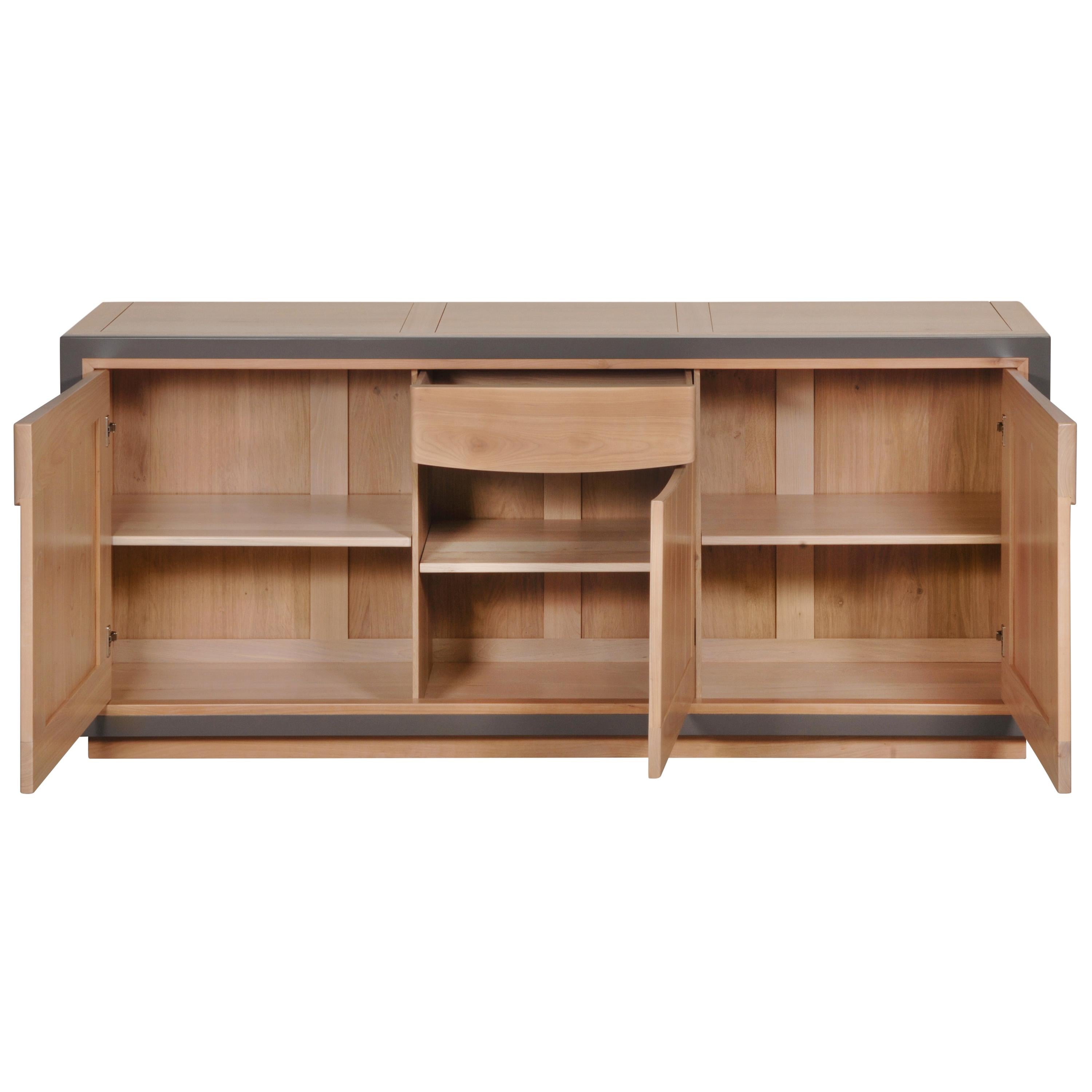 This 3 doors sideboard is made of Cherry wood and designed by Christophe Lecomte a French Designer. Christophe likes to combine right contemporary frames for this sideboard with smooths curves for the handles and the drawer.

The central drawer