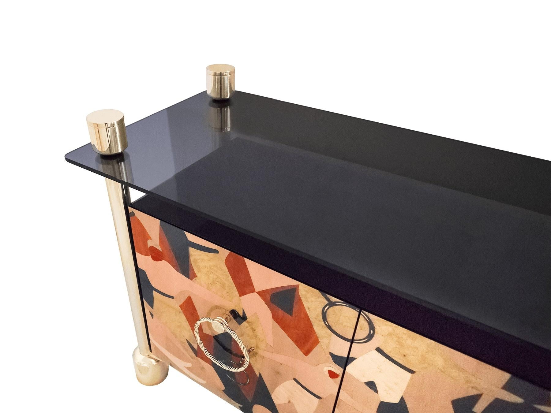 Modern Art Deco Sideboard in Wood Marquetry and Gold Stainless Steel & Glass Top  Rebus Sideboard
Rebus Sideboard is a fusion of two historical design styles: Mid Century and Art Deco.
This living room sideboard was inspired by the glamour of the