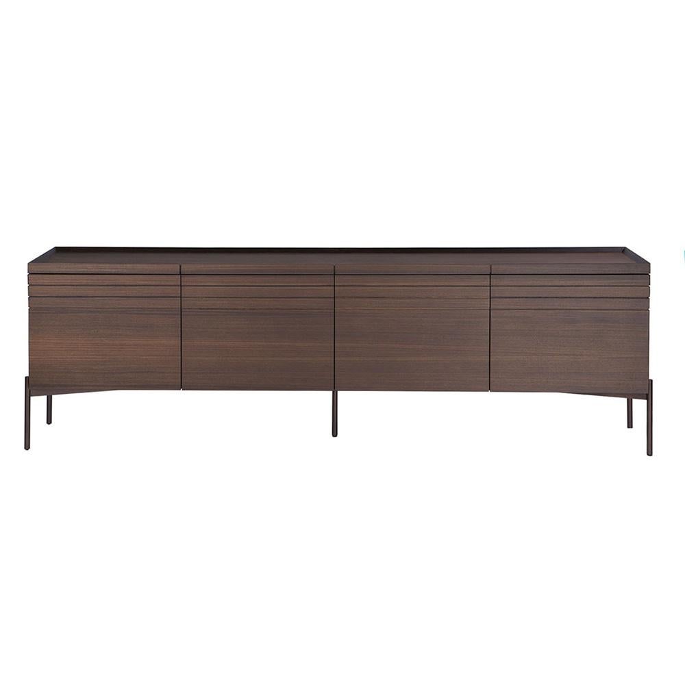 The horizontal lines carved around the cabinet along with the simple metal base, give the sideboard a more elegant dimension.
Materials : Walnut Veneer, The base is metallic. 
Available in different sizes and finishes.
The price is subject to change