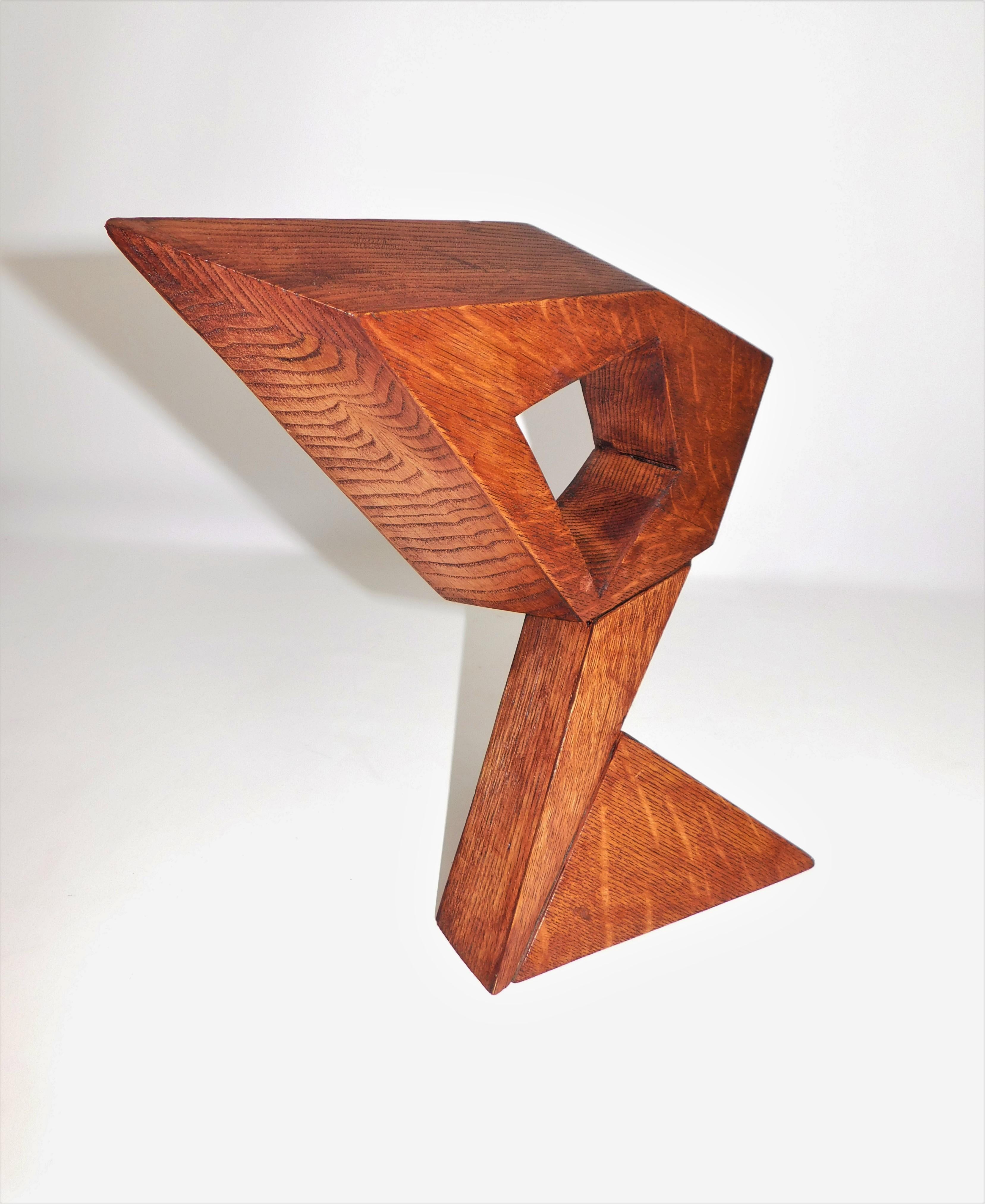 This contemporary abstract wooden sculpture was done by Czeslaw Budny a Polish-Canadian artist in the constructivist style circa 2019. This sculpture was made entirely of up-cycled, reclaimed wood from a variety of sources and utilizes the