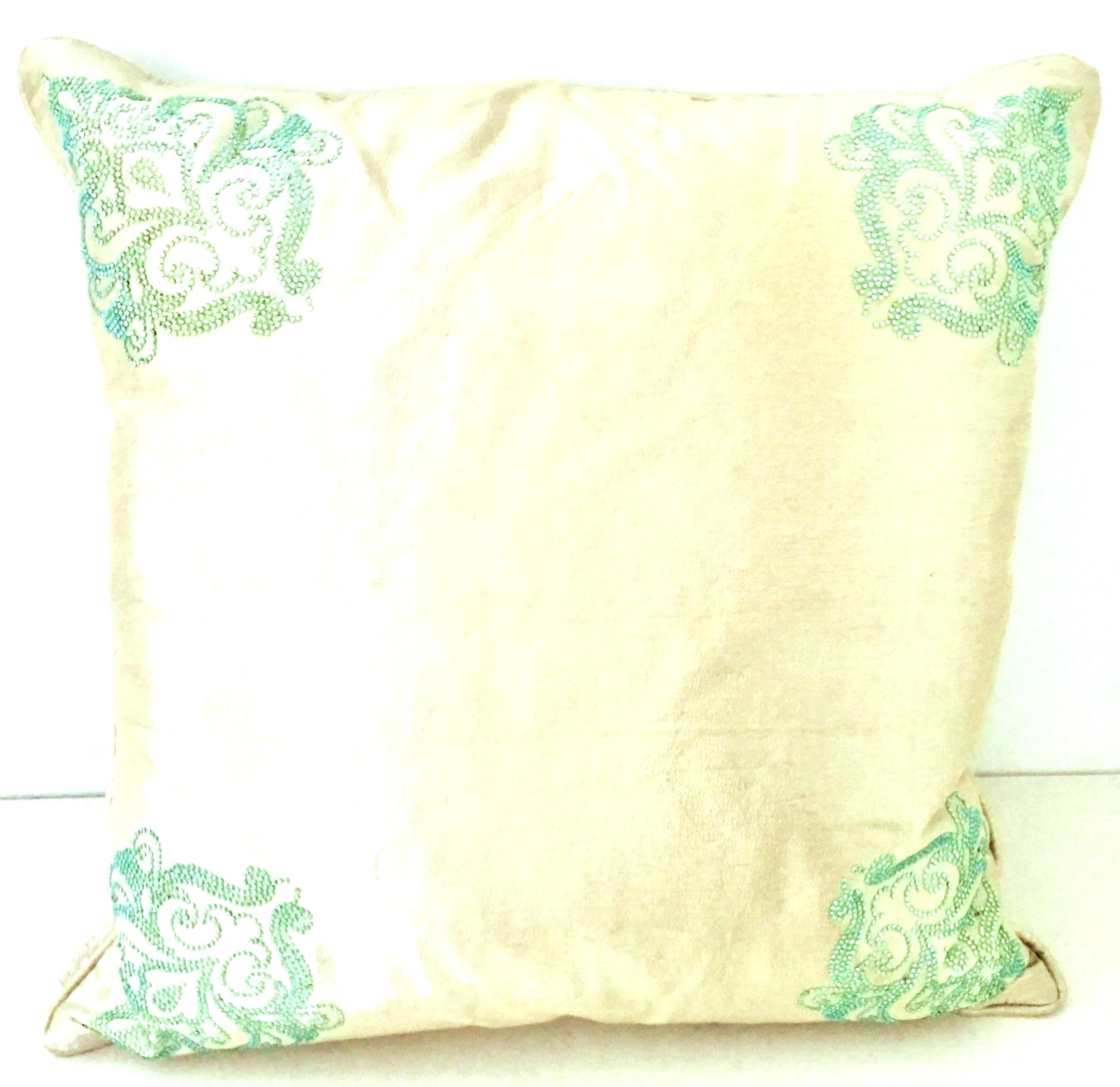 21st Century & New Stunning contemporary silk pillow in off-white with a paisley adorned green and turquoise Swarovski crystal rhinestone pattern at all four corners. Includes a down/feather cotton covered insert. Features a hidden zipper for easy