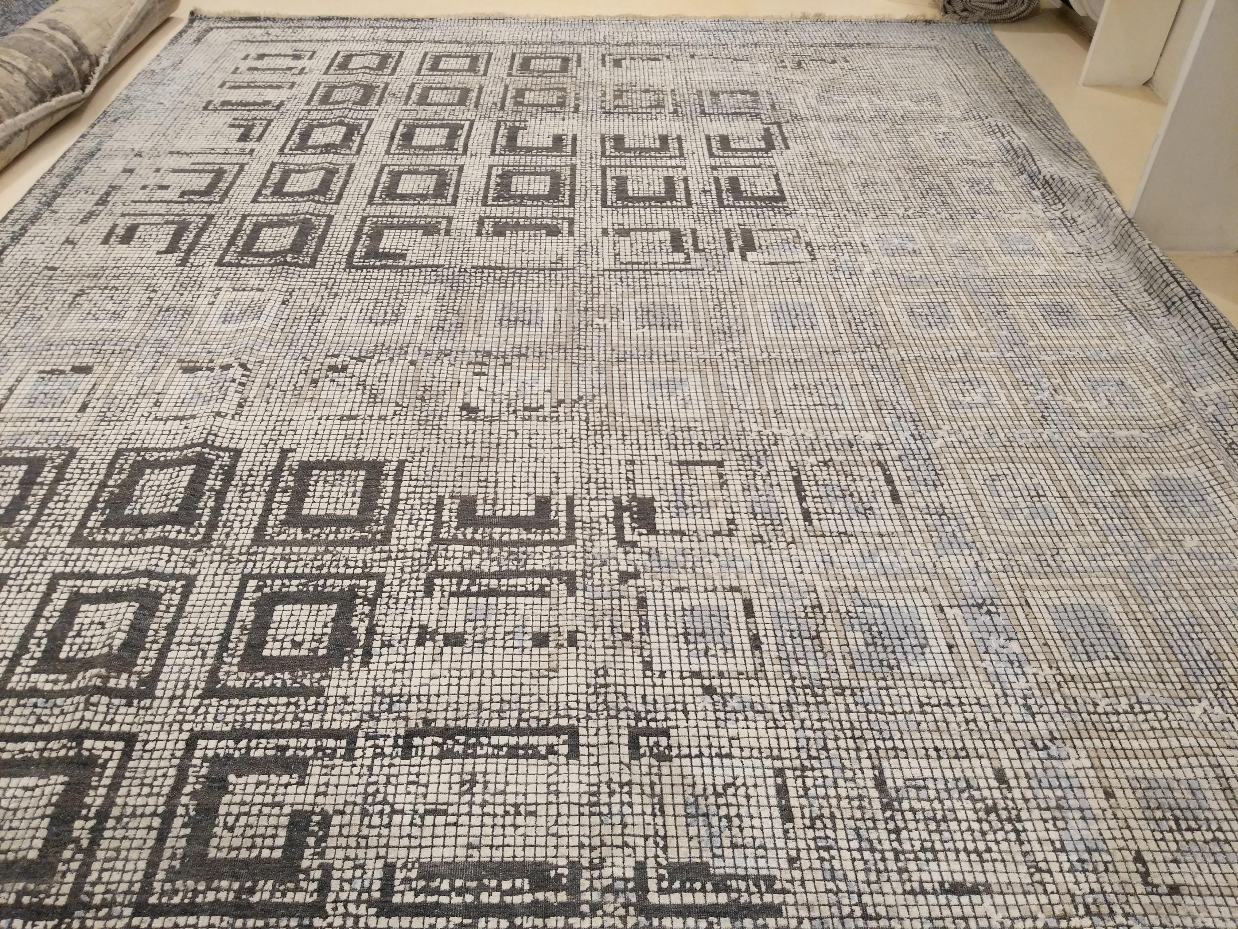 An extremely finely knotted carpet woven completely in pure silk, with a design taken from the floor mosaics of the Byzantine period. The aging effect is obtained by weaving the pattern in a different color and then shearing the pile slightly. This