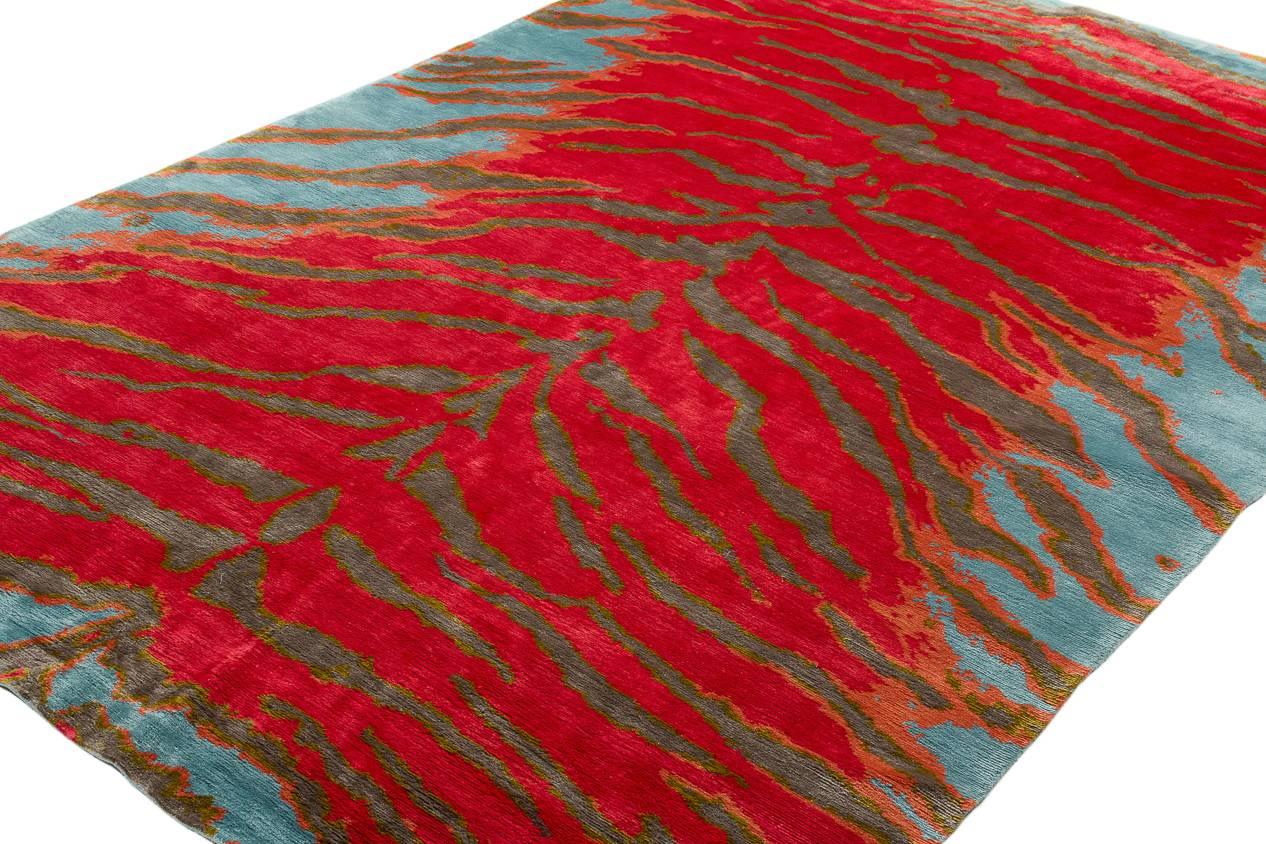 This original tiger pattern is handmade with natural silk exotic natural colors with striking vibrancy. Smokey grays and oranges complement the sensational pink-red feild set against an electric blue backdrop. Original design by Joseph Carini.