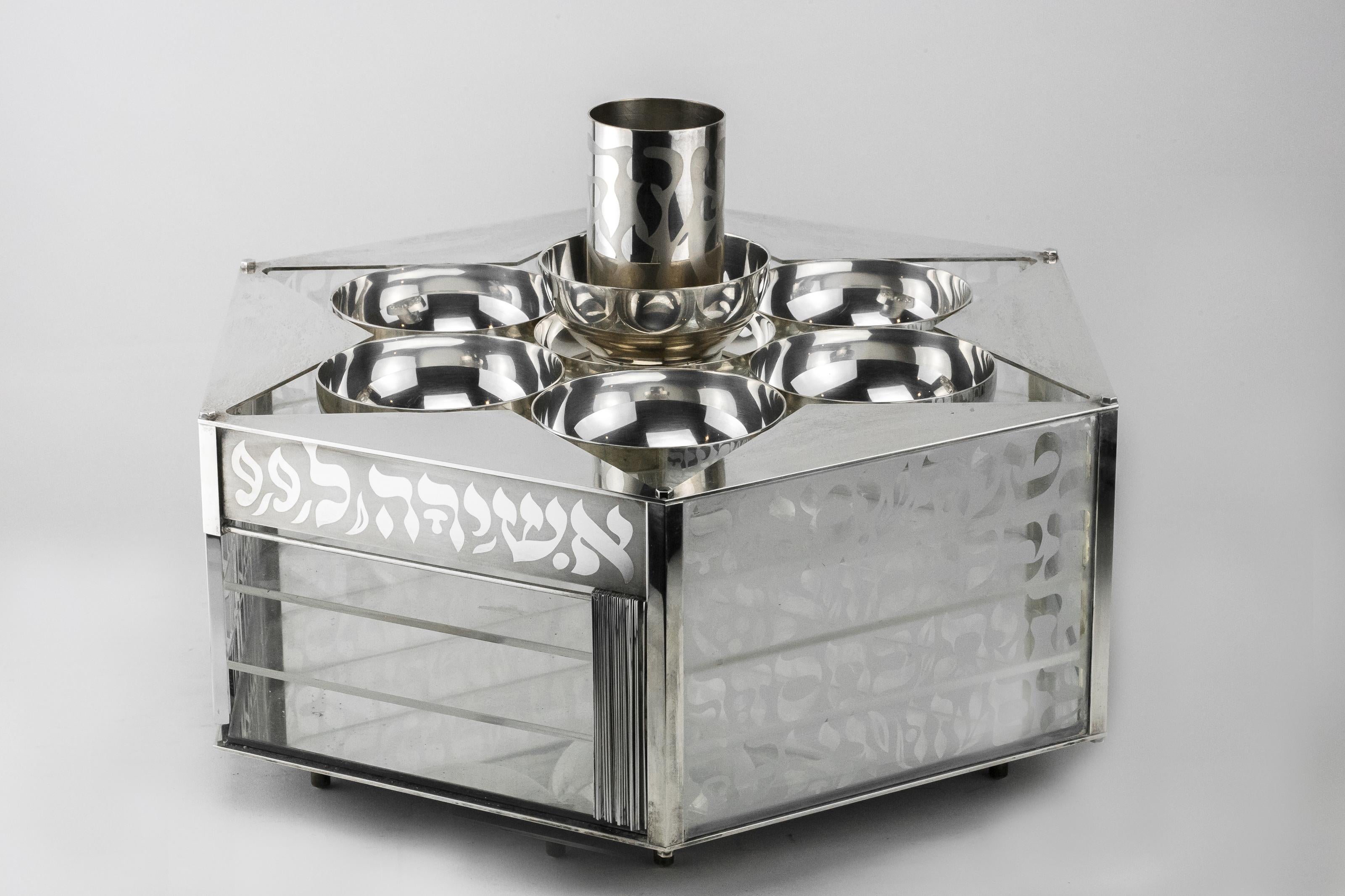 Heavy and Massive Modern silver and glass three-tier Passover set by Menachem Berman.
The top part, in a shape of a star of David, holds six silver dishes and a wine cup, six side panels are decorated with Hebrew text of the 