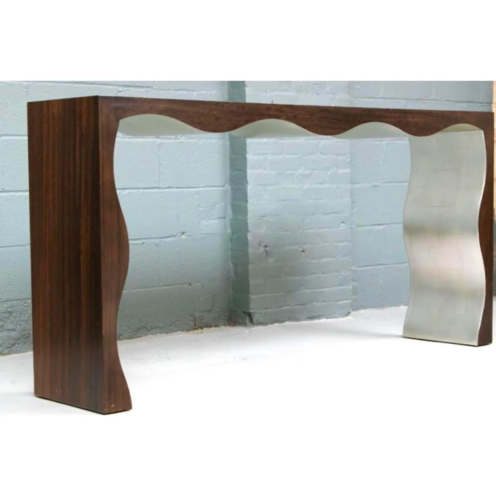 A fantastic vintage custom console table. A sleek Contemporary design with a wood grain frame and a silver leaf bottom. A winding ruffle edge adds to the frame. Acquired from a Palm Beach estate.