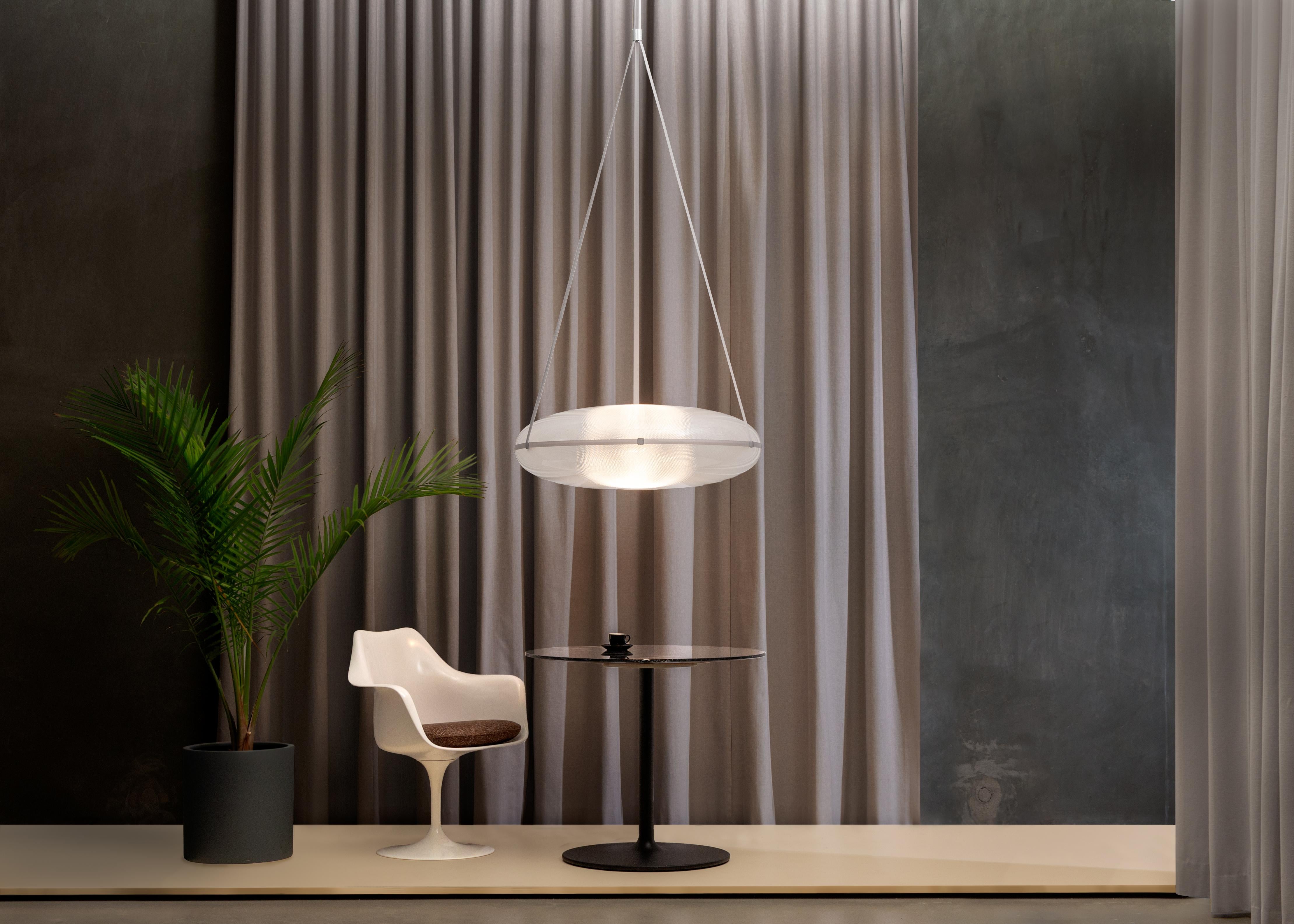Contemporary pendant lamp 'Iris'

Electrical : 
Voltage: 120 V – 277 V 
Lamp: Integral 34 W 35 V DC LED

The model shown in picture:
- Diameter: 90 cm Height. 30 cm 
- Finish: Silver
- Wire height: 300 cm (adjustable drop length)
- Modules : B and