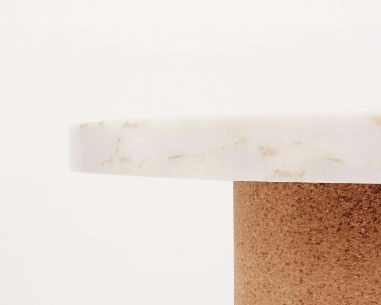 Suitable as a coffee table or side table where the contrast between the soft warm cork, meets the cold smooth marble. The distinction between the two shapes gives the impression of two worlds meeting one another.

Note: Variations can appear due to