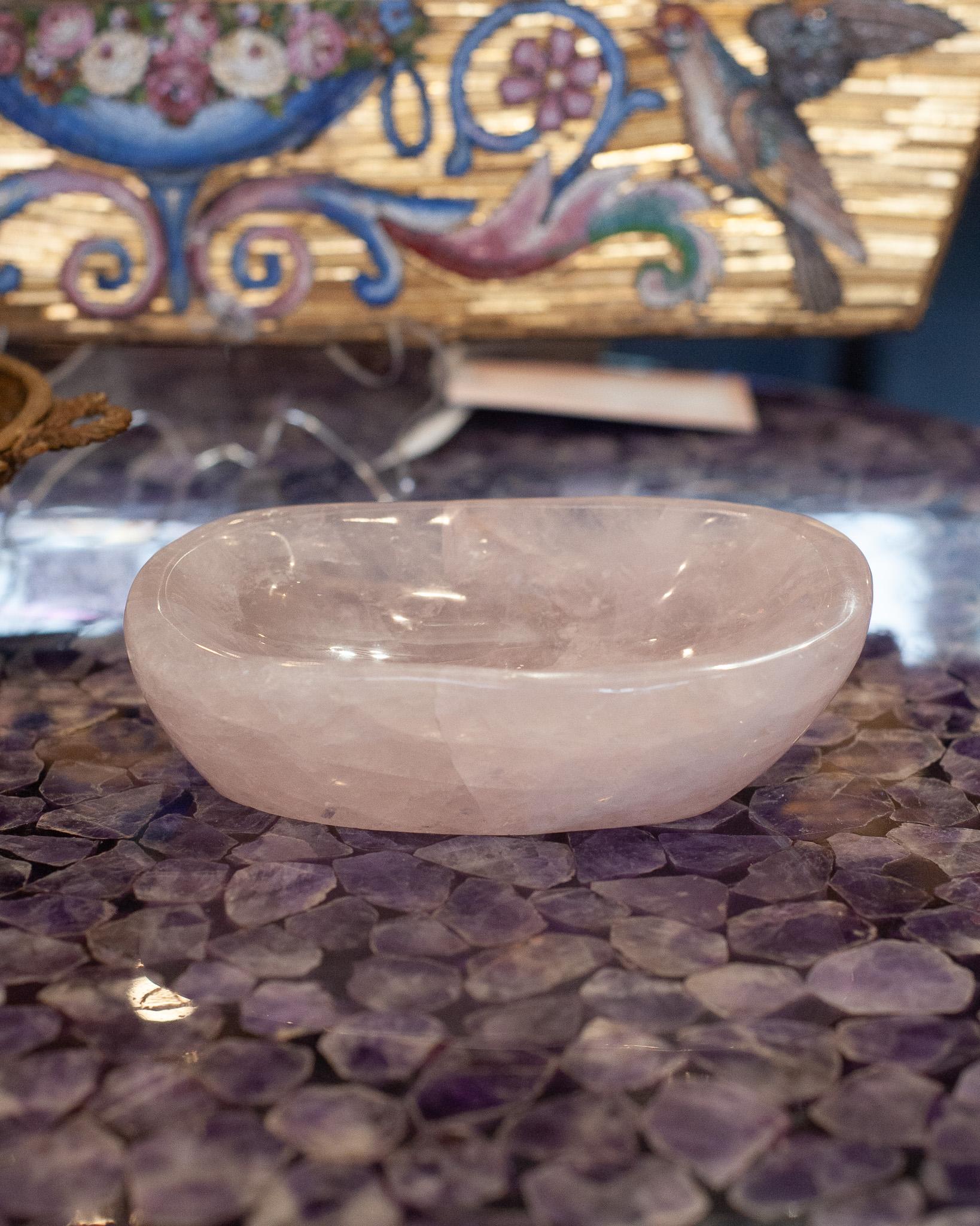 Bring the healing energy of rose quartz into your home with this beautiful carved bowl. This small yet substantial and thick hand carved bowl can filled with candies or kept sculptural as an empty vessel and placed in any space. Rose quartz, the