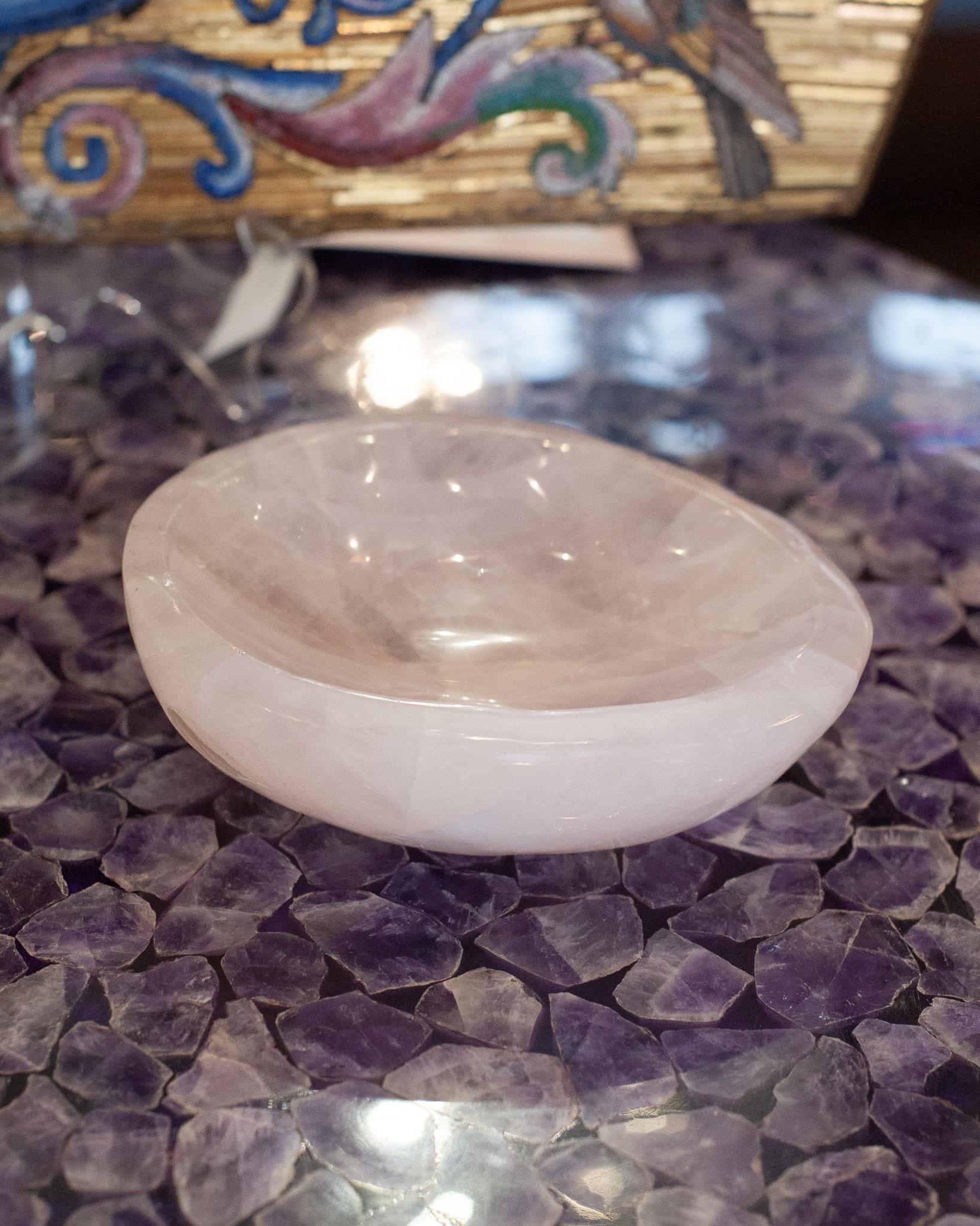 Bring the healing energy of rose quartz into your home with this beautiful carved bowl. This small yet substantial and thick hand carved bowl can filled with candies or kept sculptural as an empty vessel and placed in any space. Rose quartz, the