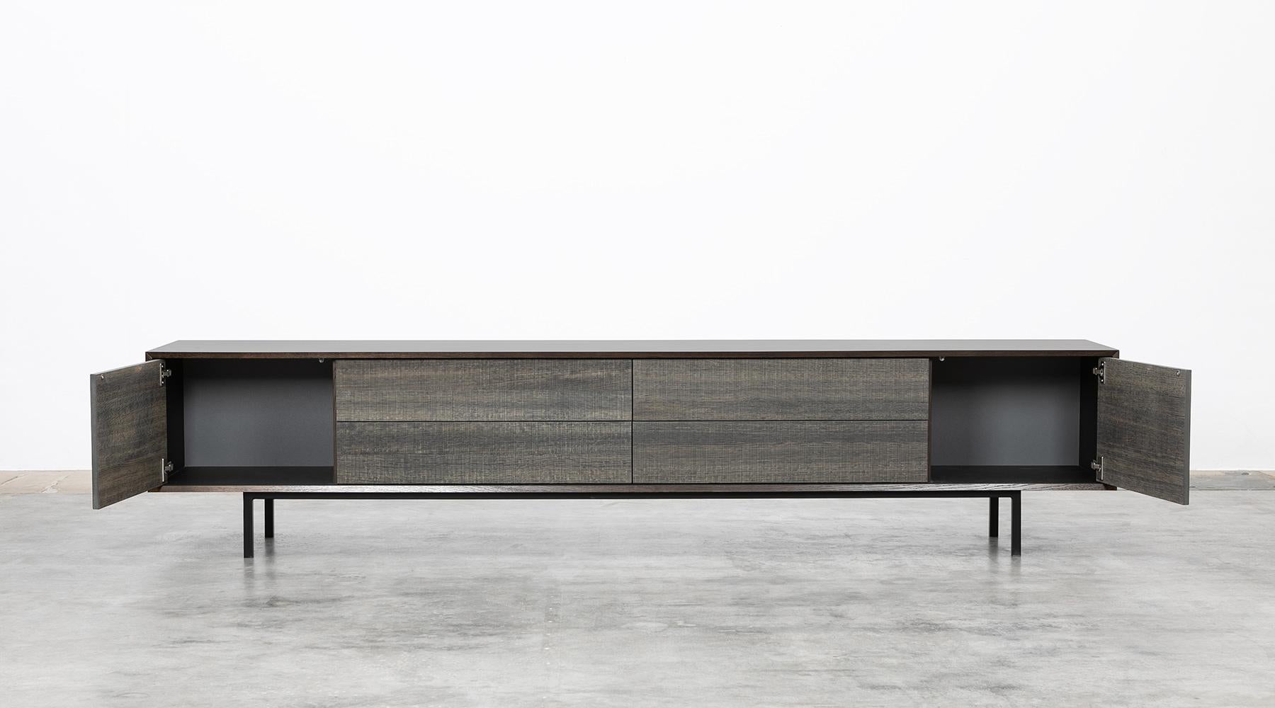 Sideboard by contemporary German artist Johannes Hock. The front of the doors and drawer of this unique piece are made of smoked oak, the corpus is in black HPL on black metal legs. Manufactured by Atelier Johannes Hock.

Hock refined his craft