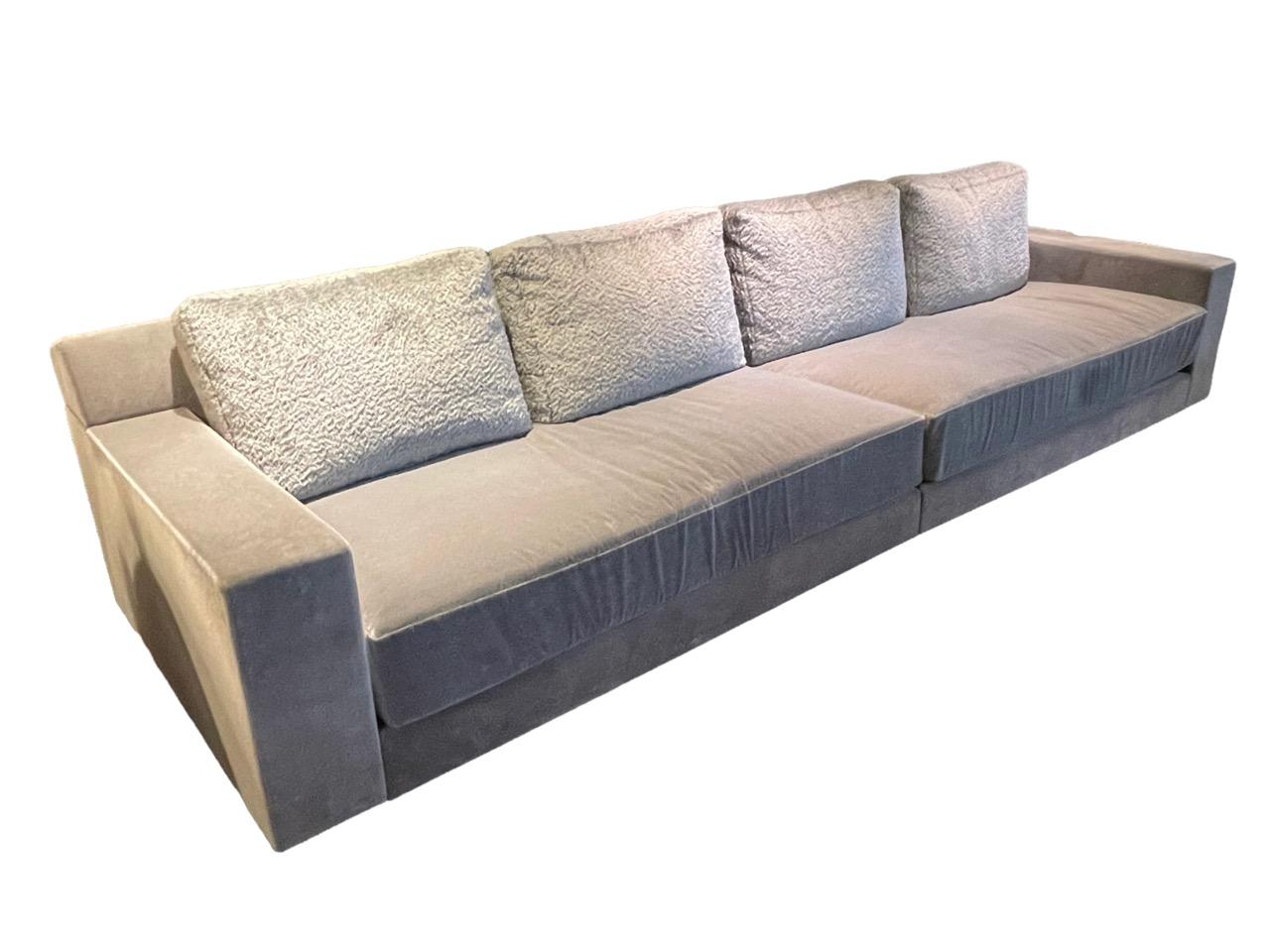 Contemporary sofa designed by Holly Hunt. Its clean-lined silhouette and modern design make it very stylish. It has been upholstered in a Holly Hunt gray mohair fabric and high-durability velvet called Mammoth. The legs are custom-made in bronze.
 
