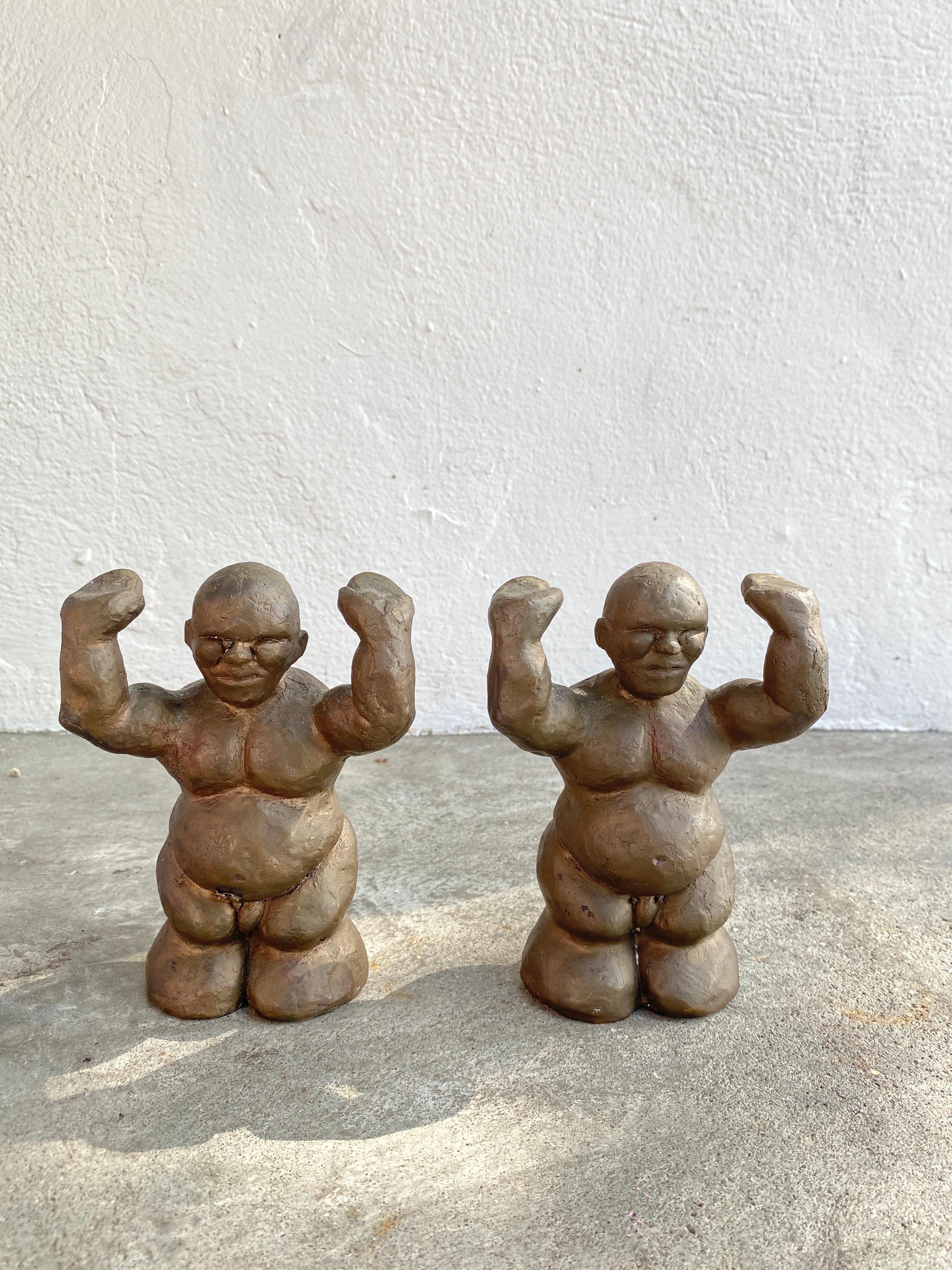Vintage pair of heavy brass sculptures, two naked men holding arms up.
Signed 2 and 3 of 20