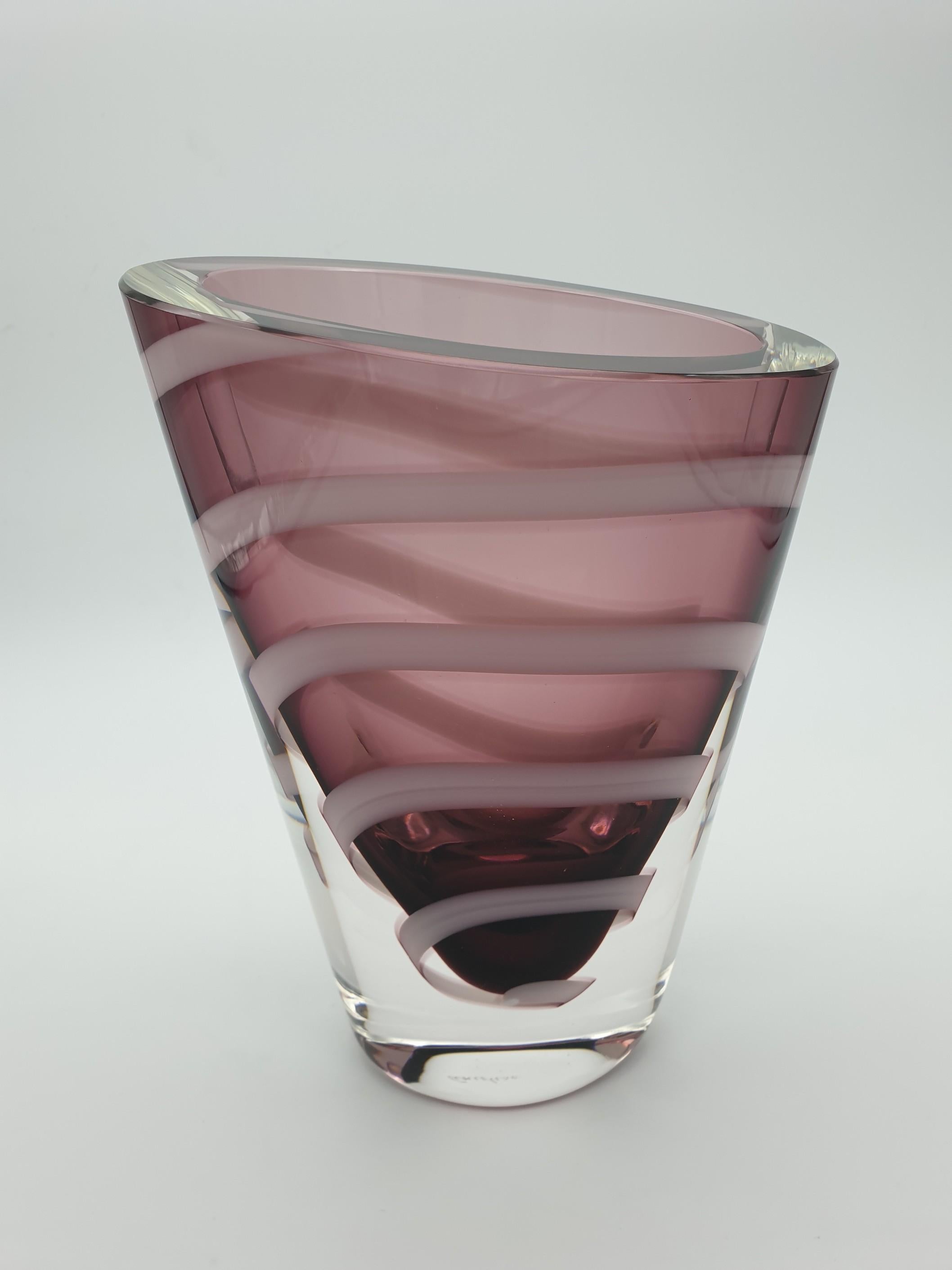 Murano glass solid vase, with thick walls and oval cross section by the glass-factory Gino Cenedese e Figlio. The ametyst color is highlighted by a contrasting milky white spiral. The geometry and dynamism in this vase is impressive: the spiralling
