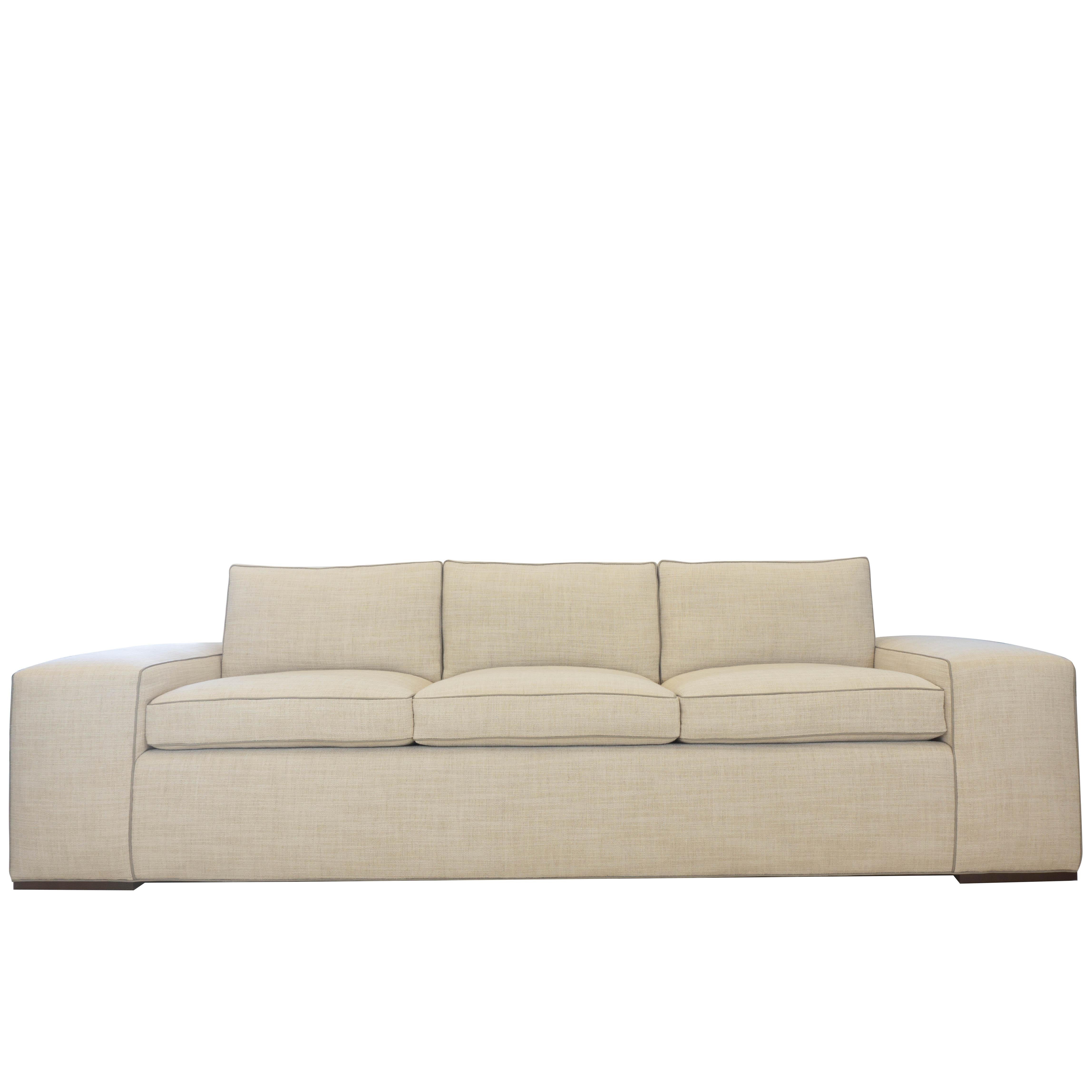 Contemporary square arm sofa with faux leather welting. Arm is 13
