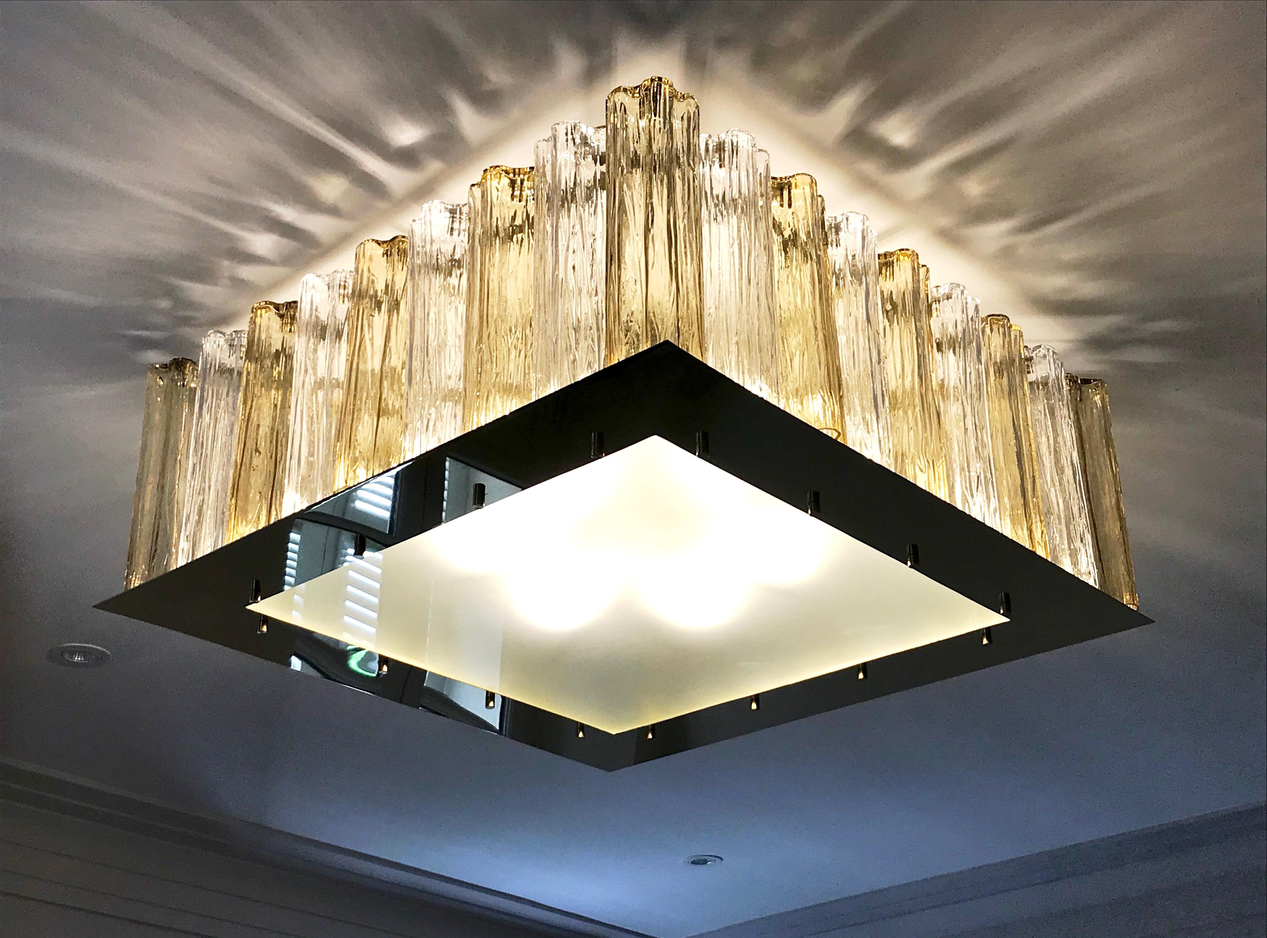 A contemporary Italian bespoke Art Deco design, entirely handcrafted in Italy, chandelier customizable as flush mounts or pendants, here with a gold brass structure in a geometric square shape, highlighted and made precious by a brass staging