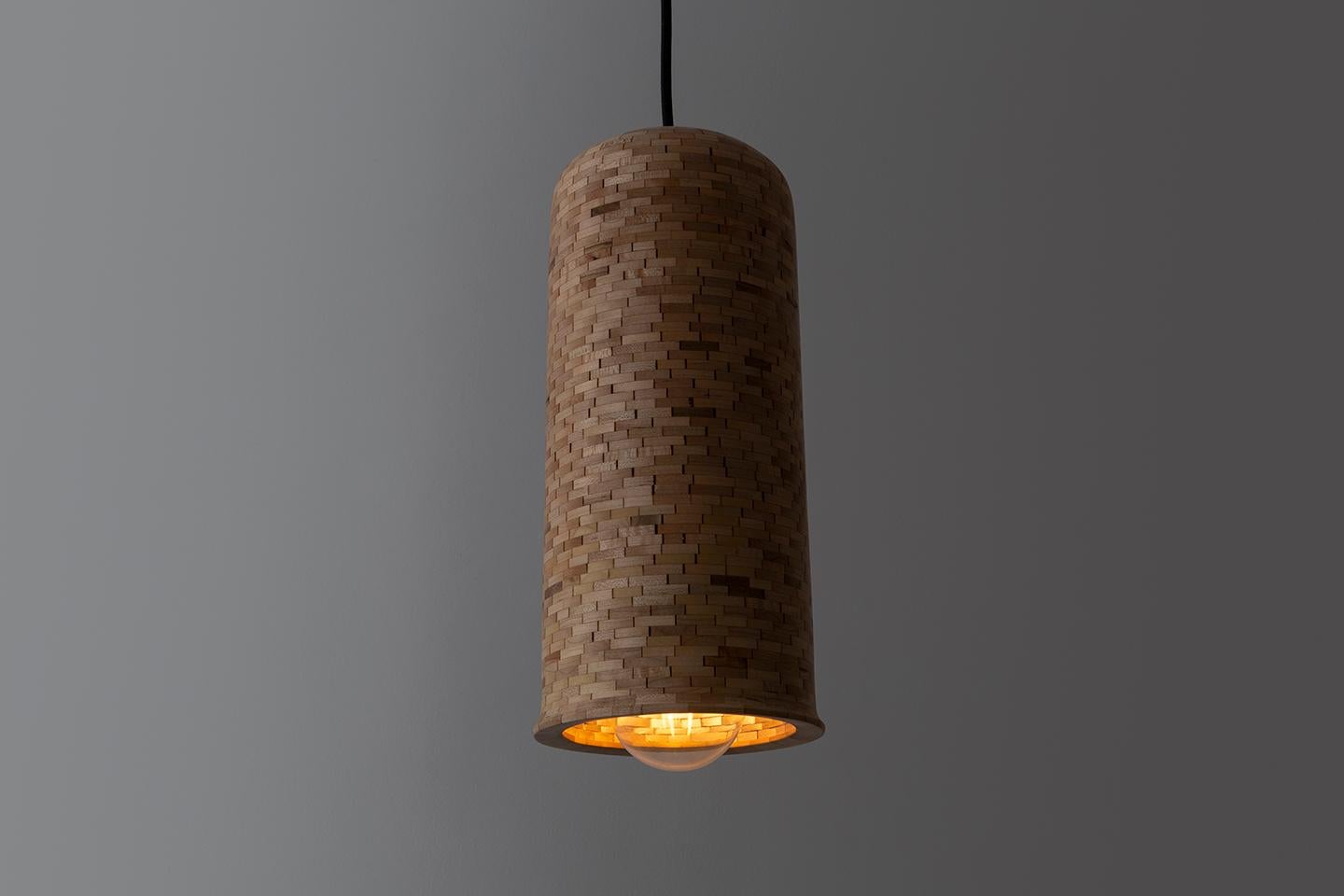 The STACKED cylindrical bell-shaped pendants shown here are made of salvaged Maple. All pendants are hand-built custom per your specifications. Larger or smaller, used individually or as a grouping, a different profile or a different wood, they are