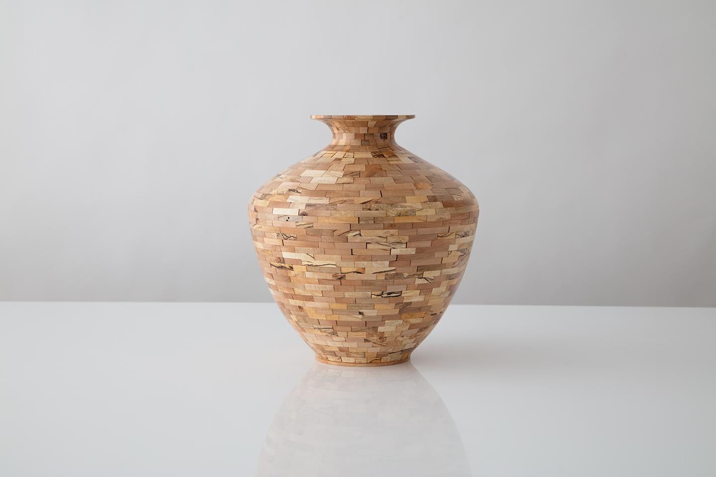 This vessel has not been turned on a lathe. It was hand-built hollow, Stacked piece by piece, layer by layer, all the while controlling the wall thickness as well as the profile. This piece was made using reclaimed spalted maple salvaged from the