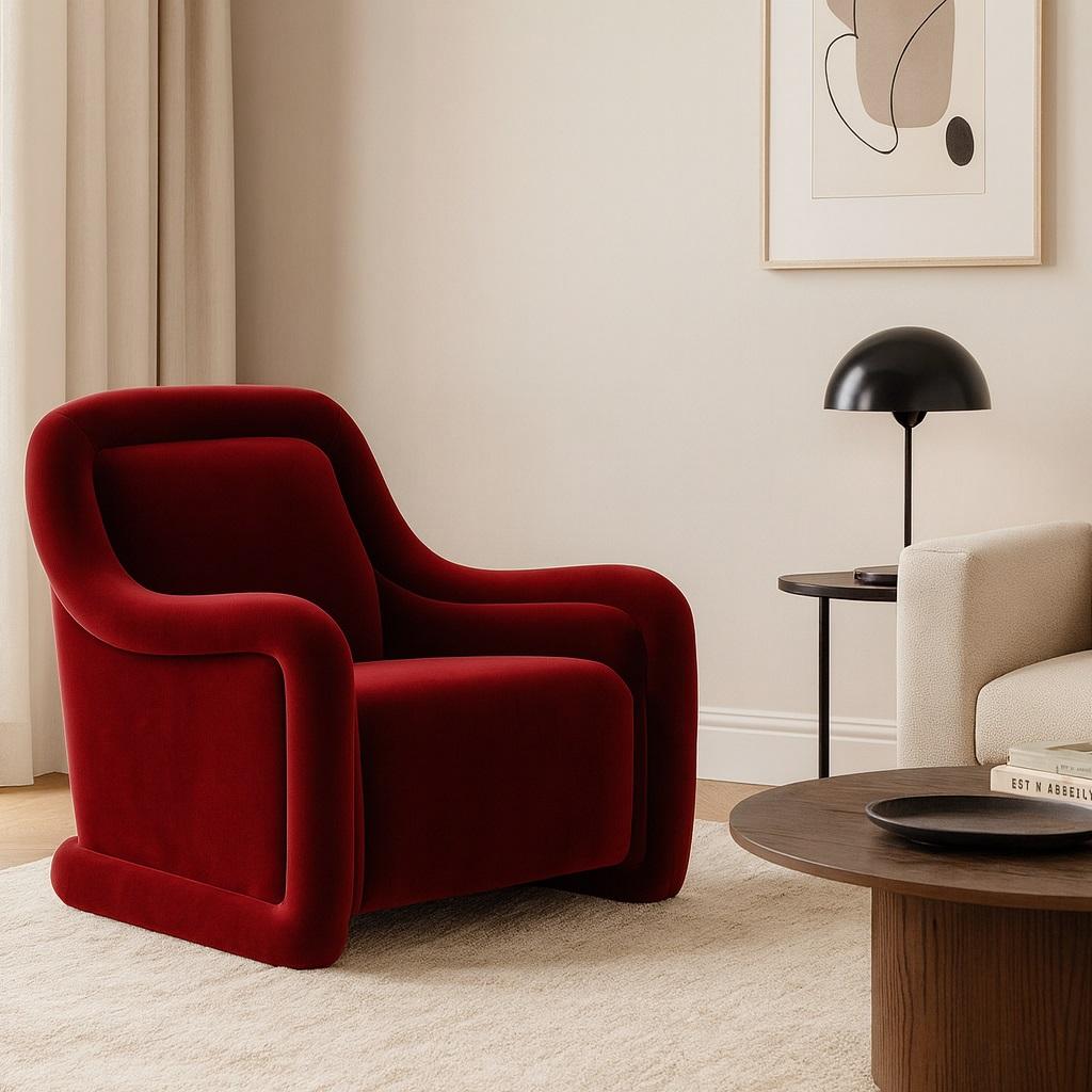 This stylish and inviting armchair is a study in soft, sculpted form. It features a plush, generously upholstered seat and backrest designed for superior comfort. The chair's most distinctive element is the oversized piping that gracefully encircles