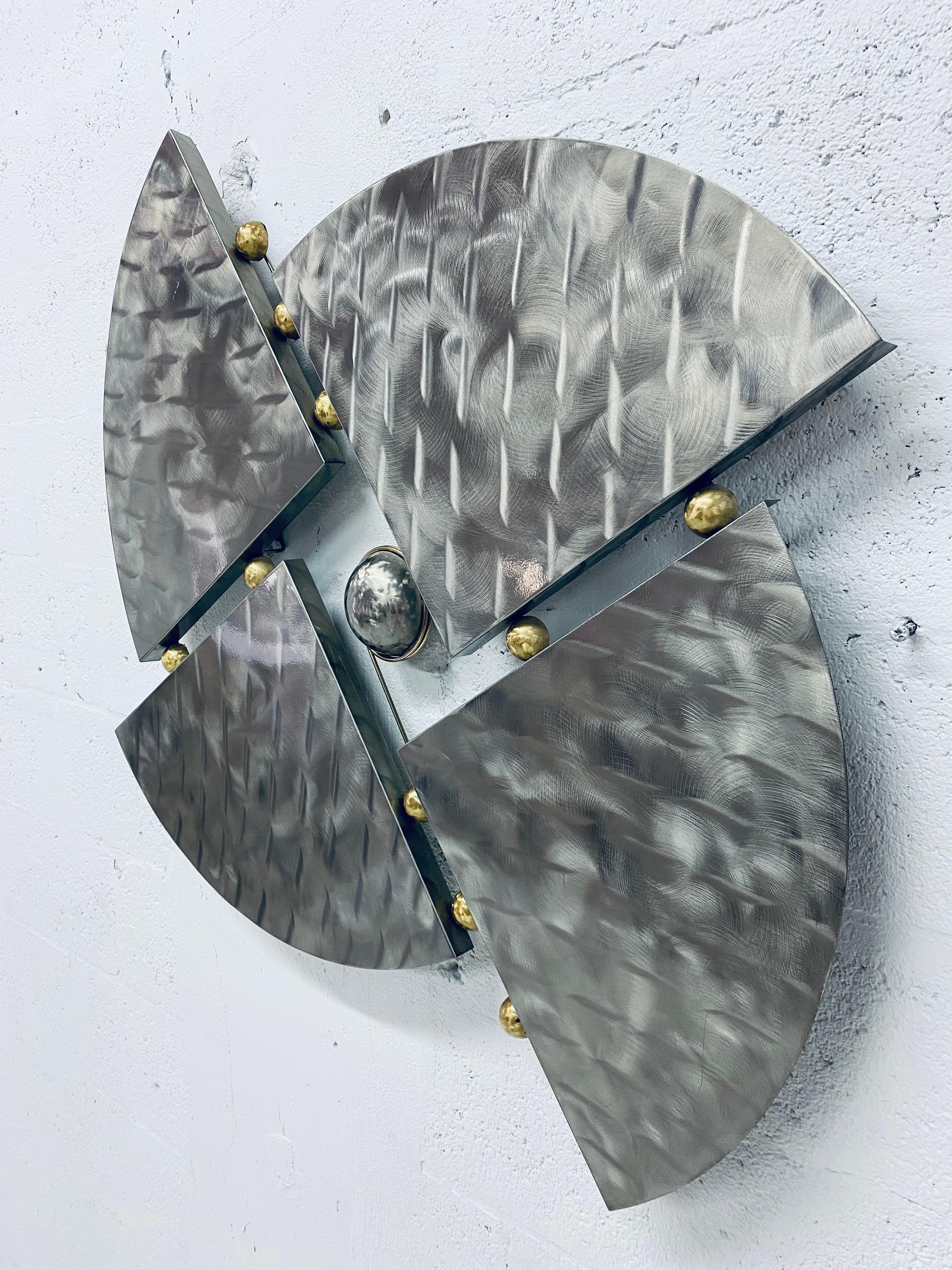 Metal wall sculpture with brass accents from the mid 90s. Unsigned.