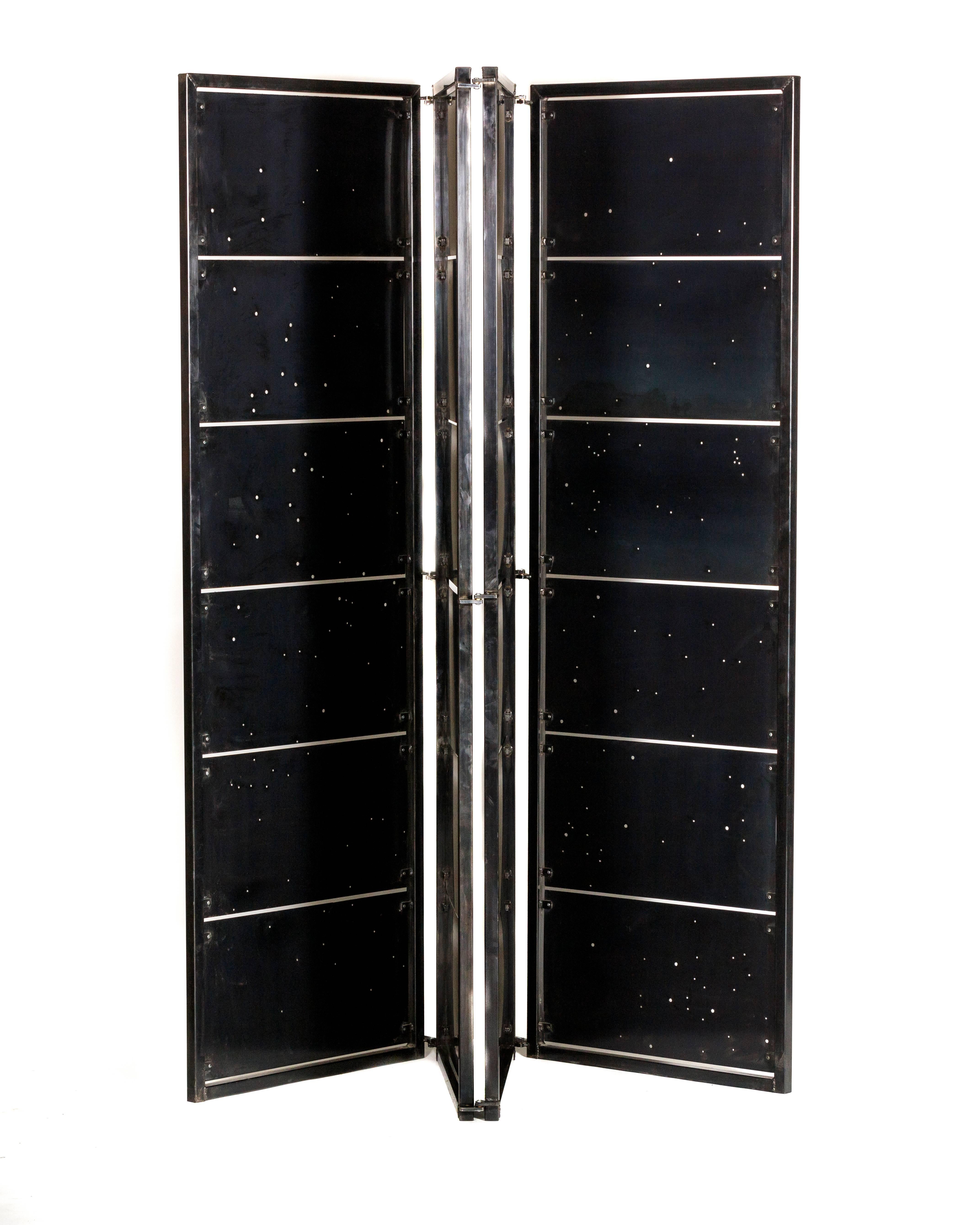 Derived from the constellations of the Equatorial region, this shoji screen is made of blackened steel panels and frame with bronze hardware accents. This very original piece provides privacy and beauty to any room.

With backlighting that you