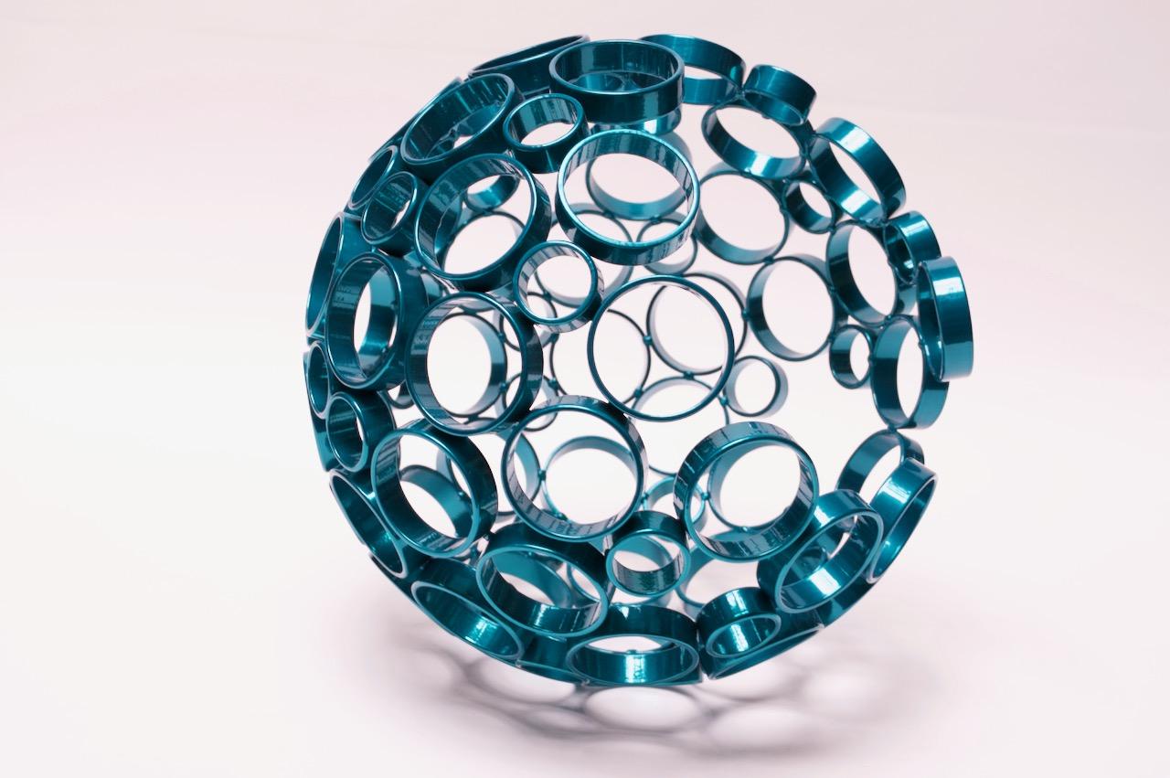 2019 sculpture by Industrial metal and iron artist, Scott Behr (Brooklyn, NY). Semi-circular 'orb' form composed of welded steel circles, powder coated in a metallic teal finish. Signed and dated.
Measure: 13.5