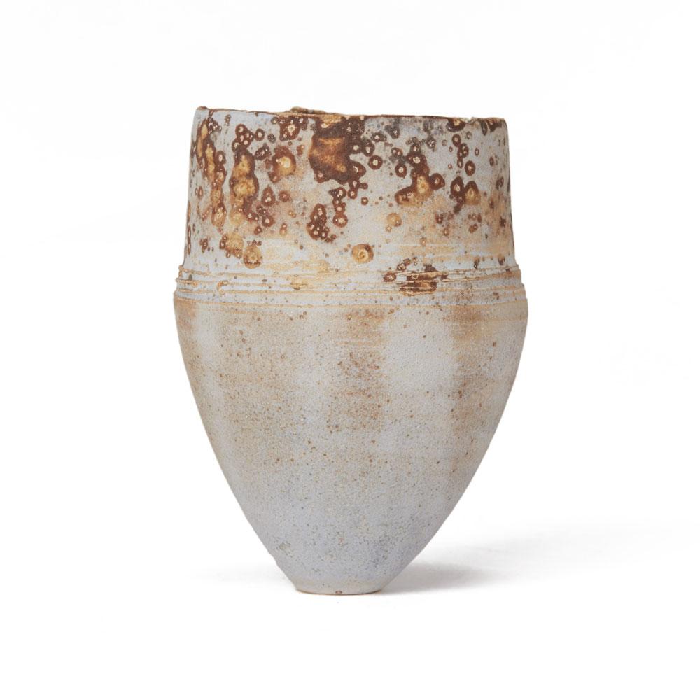 A stunning contemporary hand thrown Studio Pottery vase with a matted textured finish with oxidised brown glazes creating a pitting effect around the upper rim. The vase is very finely made standing on a narrow rounded foot and has an impressed seal