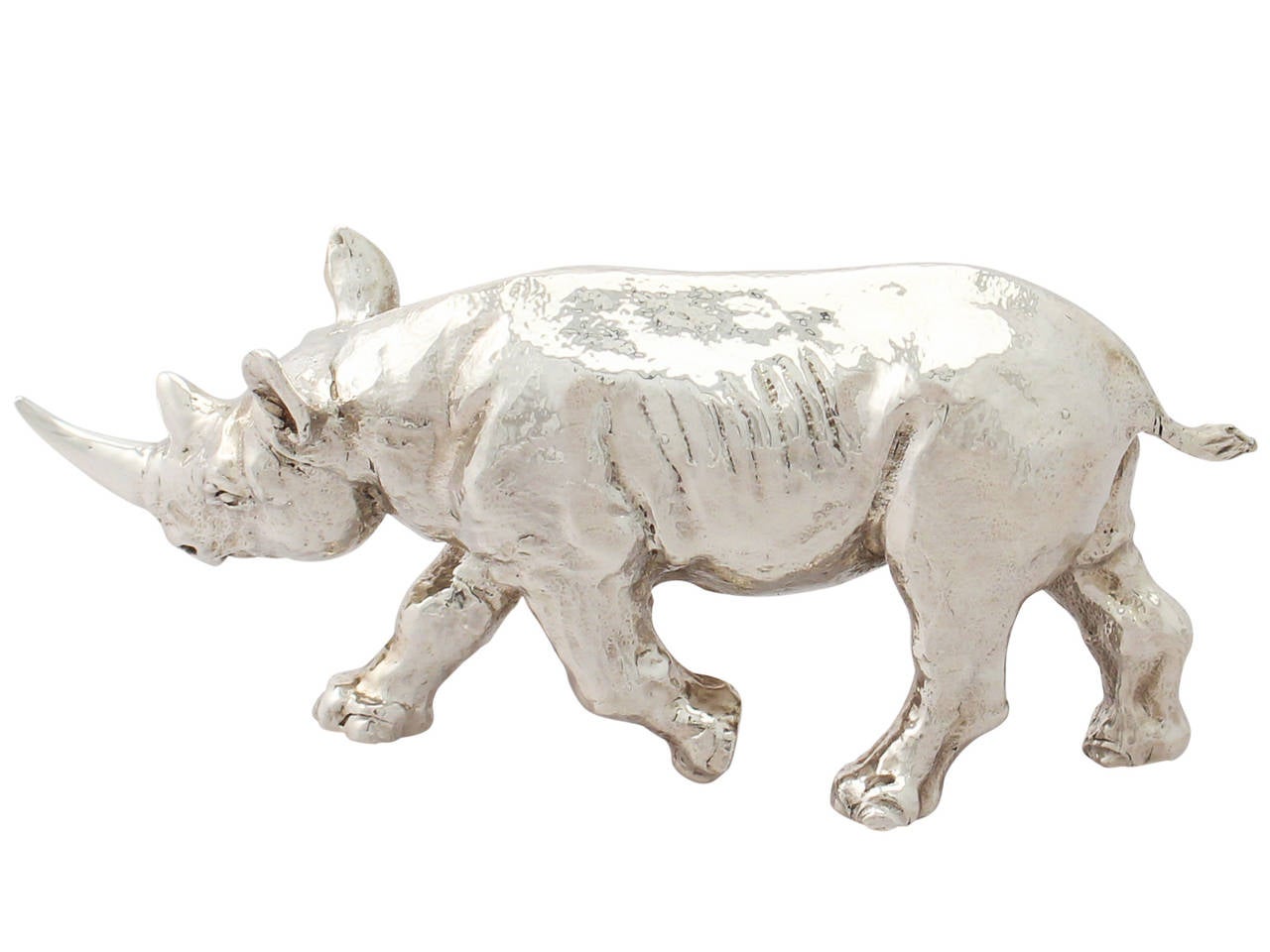 A fine contemporary cast English sterling silver model of a Rhinoceros; part of our animal silverware collection.

This fine contemporary cast sterling silver ornament has been realistically modelled in the form of a rhinoceros.

This silver