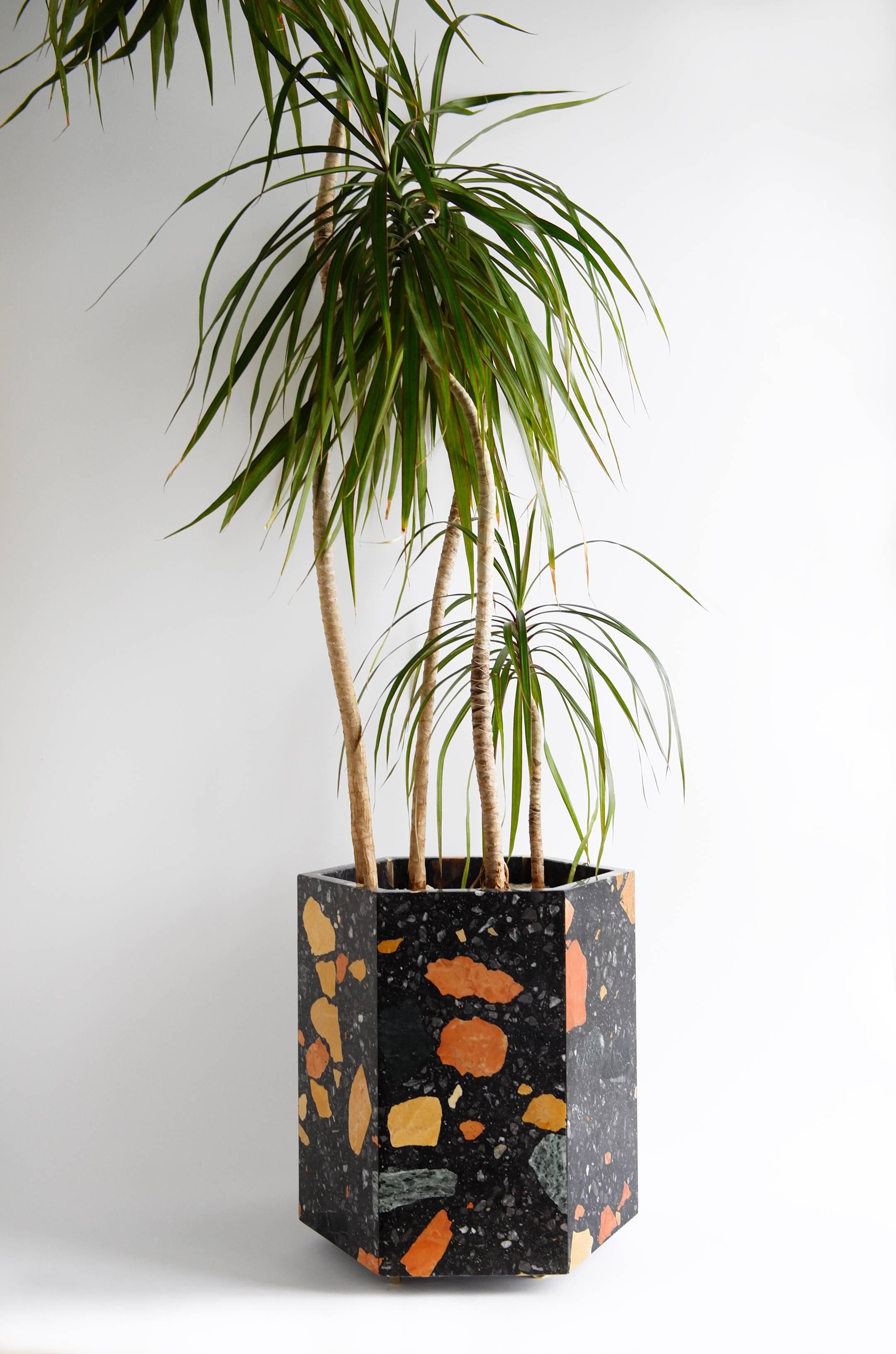 This stone planter is made of the highly coveted Marmoreal, a special aggregate terrazzo material produced by Dzek and designed by Max Lamb.  Shown in Black Marmoreal and also available in white.

Hexagonal planter is 16 tall and includes small