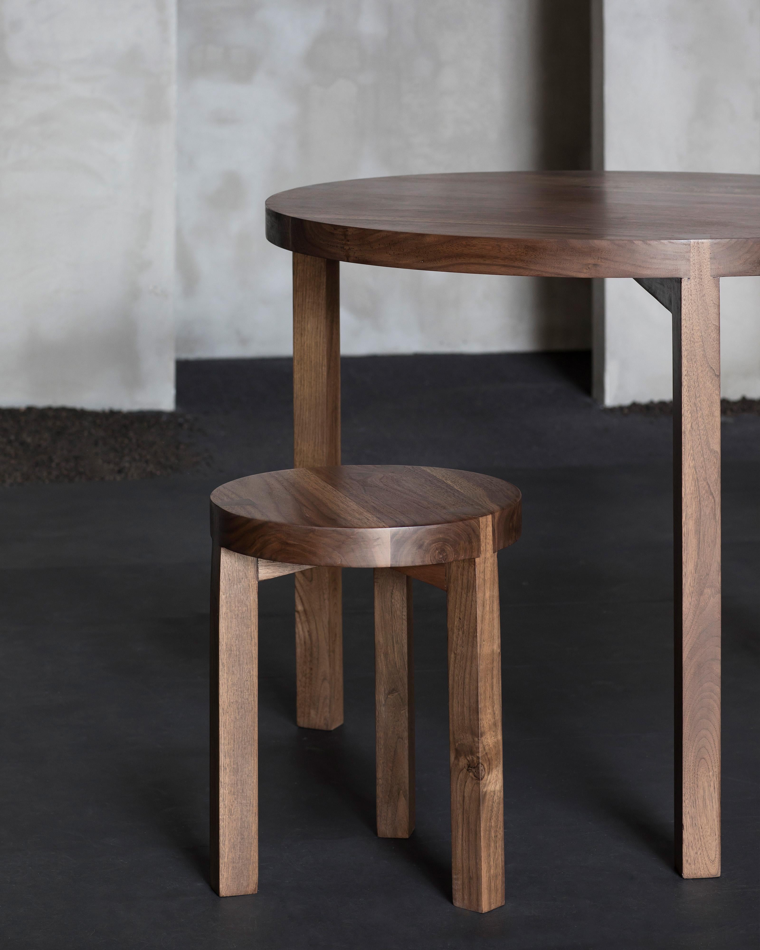Stool in Walnut 'Solid' by Atelier 365 x Valerie Objects
Dimensions: D. 35 x H. 45

Fascinated by traditional wood joints, Greindl constructs wooden furniture without any nails or screws. Every joint is cut by hand, using chisels and a Japanese