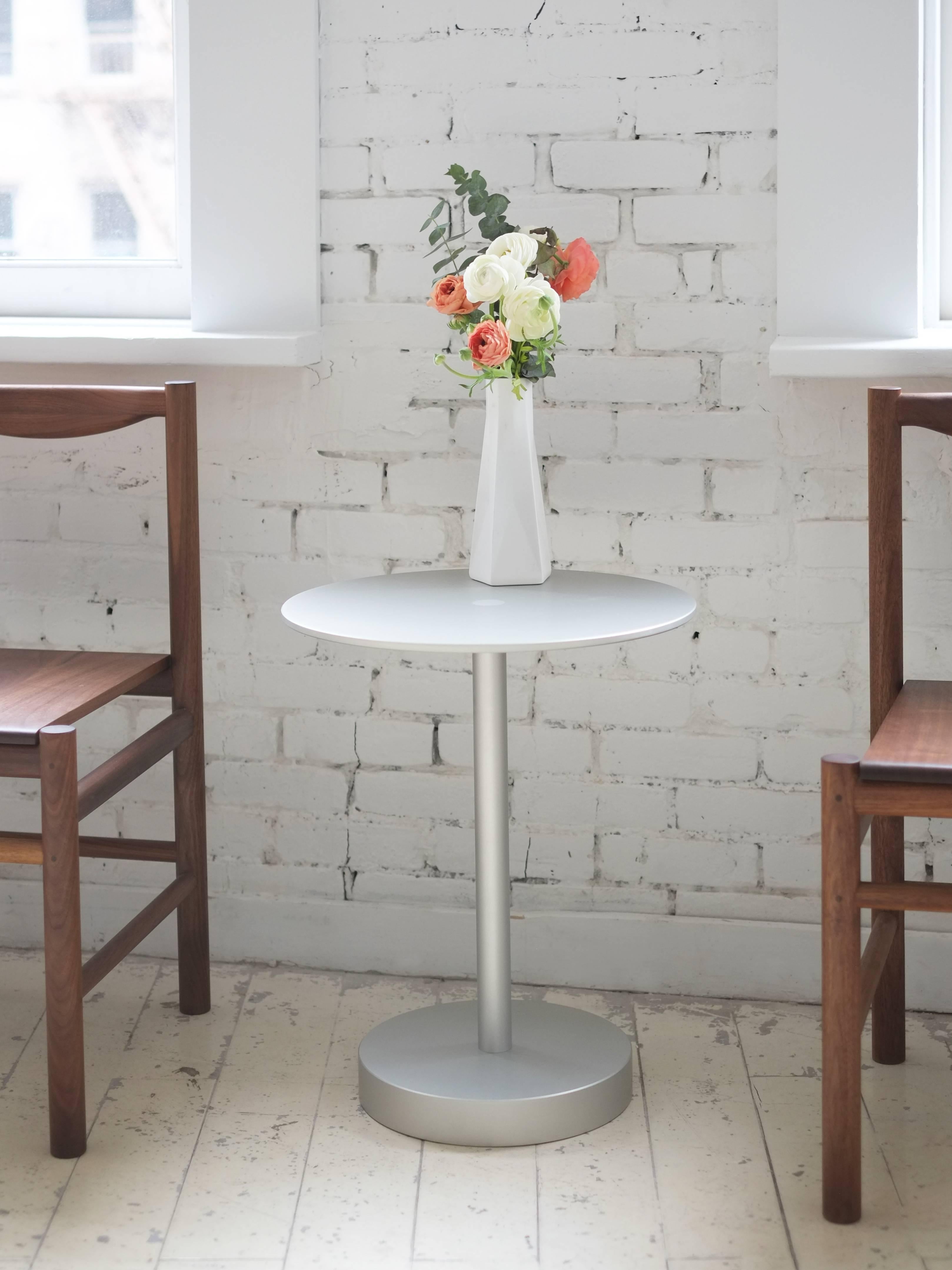 This refreshing, contemporary approach to a classic side table design features a surface connection detail centered in the precision milled 3/8” plate top. The robust 2” thick bottom is connected via a 1 1/2” solid machined stem. The perfect