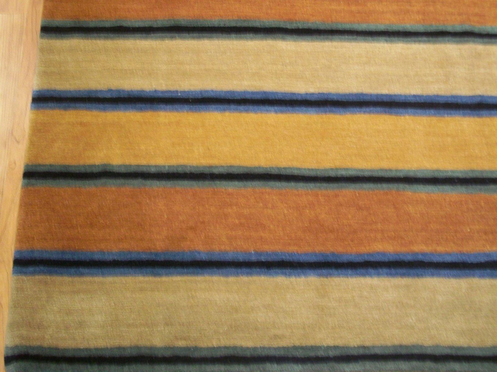Contemporary stripe rug
Colors: Charcoal, rust, gold, beige and blue.