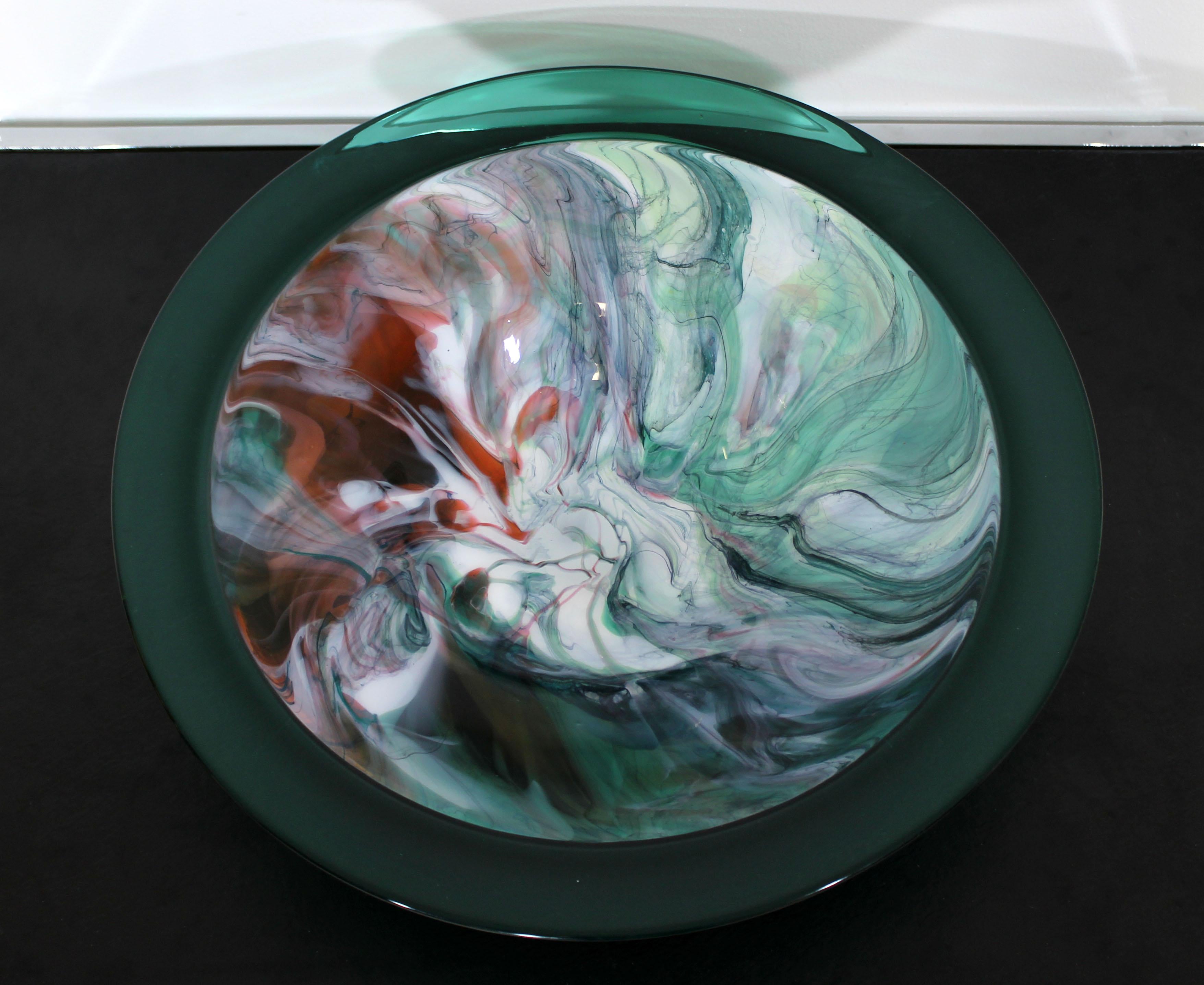 For your consideration is a beautiful, glass art bowl, with a green encalmo rim and swirl stone like design in the centre; signed on the bottom by the artist, circa 1992. In excellent condition. The dimensions are 18
