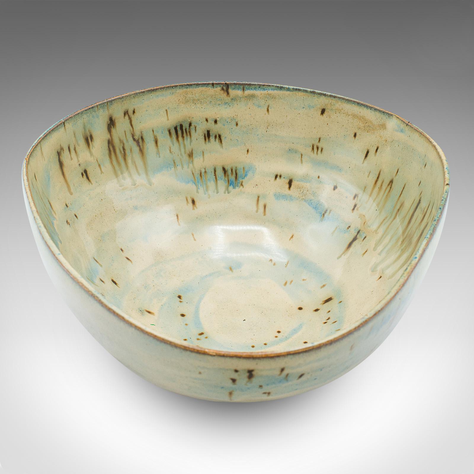 
This is a contemporary studio pottery fruit bowl. An English, ceramic decorative serving dish dating to the turn of the millennium. 

Unusual form, with a distinctive decorative finish
Displays a desirable contemporary order throughout
Of softened