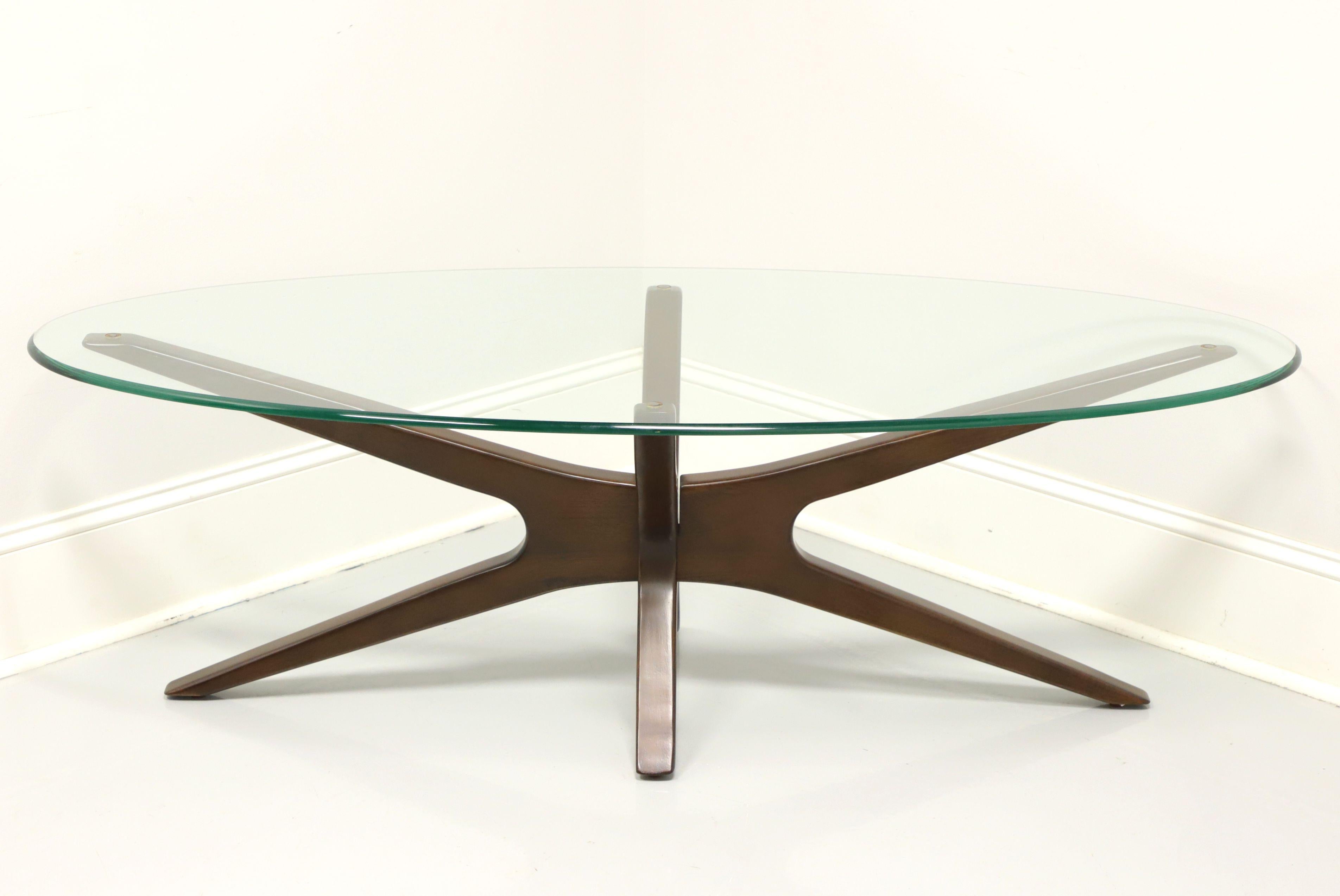A Contemporary glass top cocktail table in the style of a classic mid century design by Adrian Pearsall, unbranded. Mahogany base in a crossed 