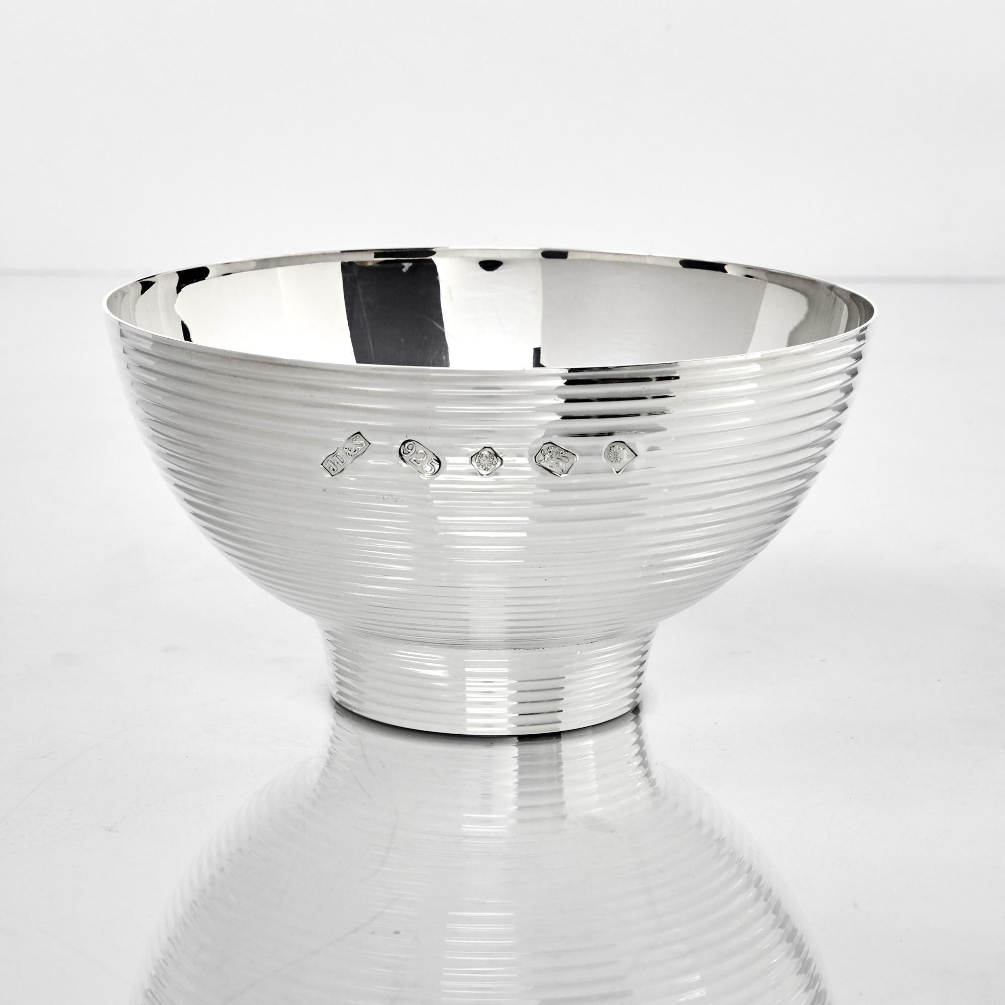Silver rose bowl of contemporary design. The exterior has stepped and graduated ribbing and the inside has a brightly polished smooth interior. It is stamped with Queen Elizabeth II's commemorative Silver Jubilee hallmark, marking the 25th