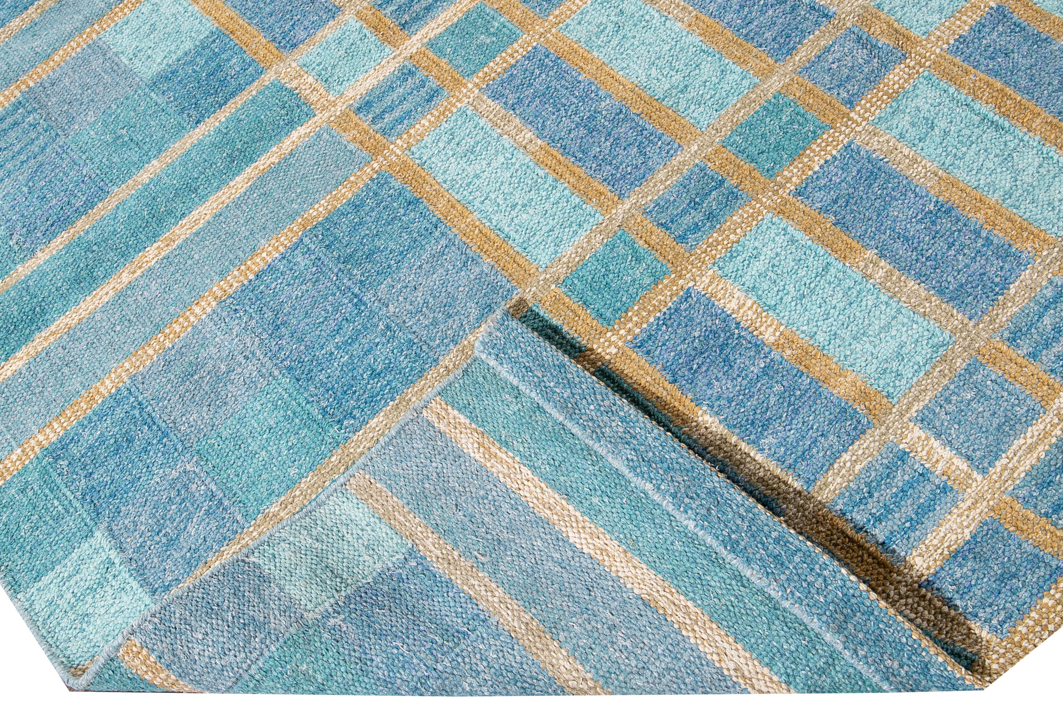 Beautiful modern oversize Swedish-style wool rug with a blue field. This Swedish rug has accents of yellow in a gorgeous all-over geometric square checks pattern design.

 This rug measures: 12'3