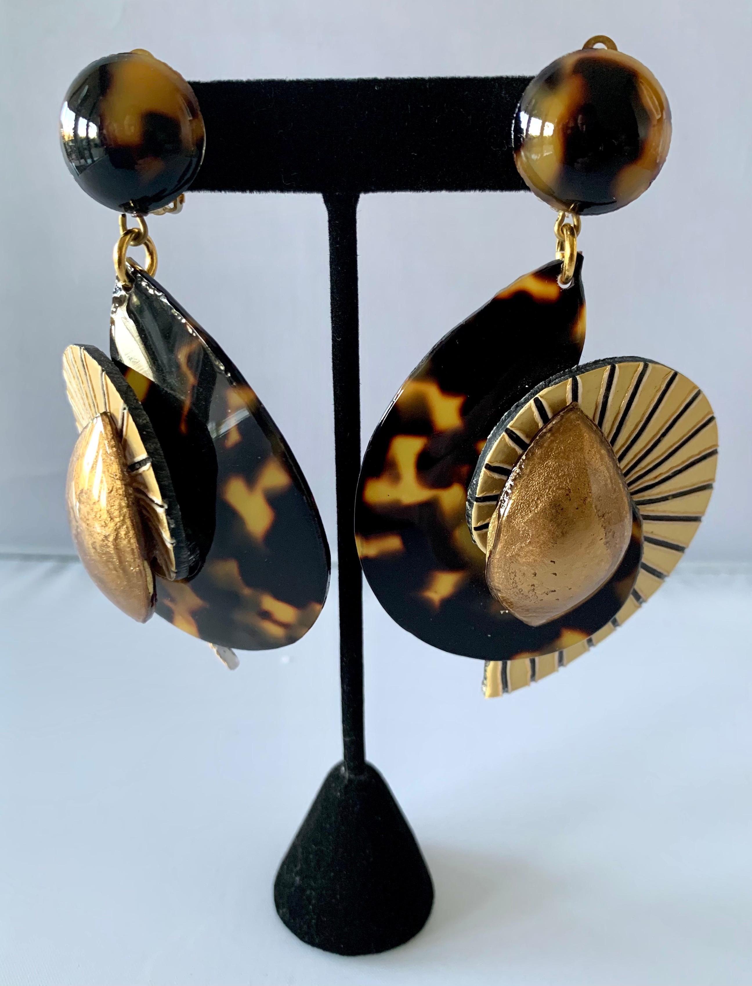 Contemporary clip-on statement earrings composed out of resin and enamel featuring a large swirl design in striped gold and faux tortoise - made in France.  