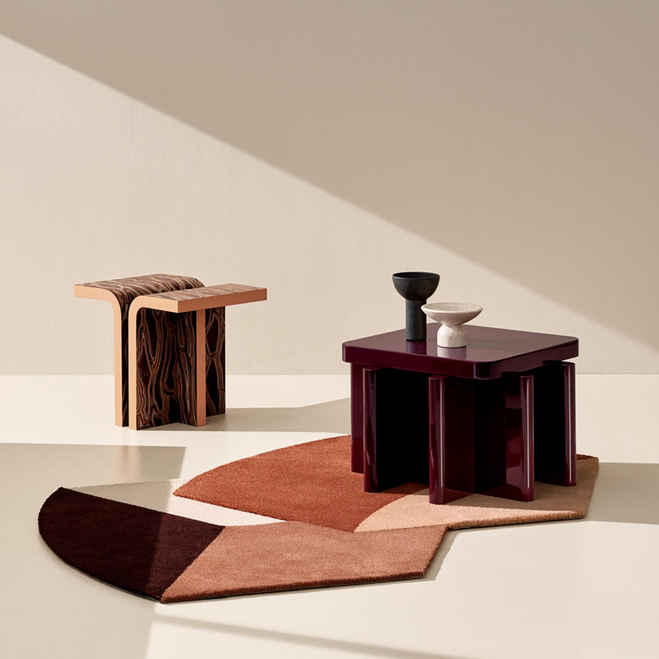 Spina is a collection of lacquered tables and seatings.

The lacquered surfaces and consistent rhythm of the planes create a visual play of light, shadow and reflection, adding depth and richness to this already visually graphic collection. The