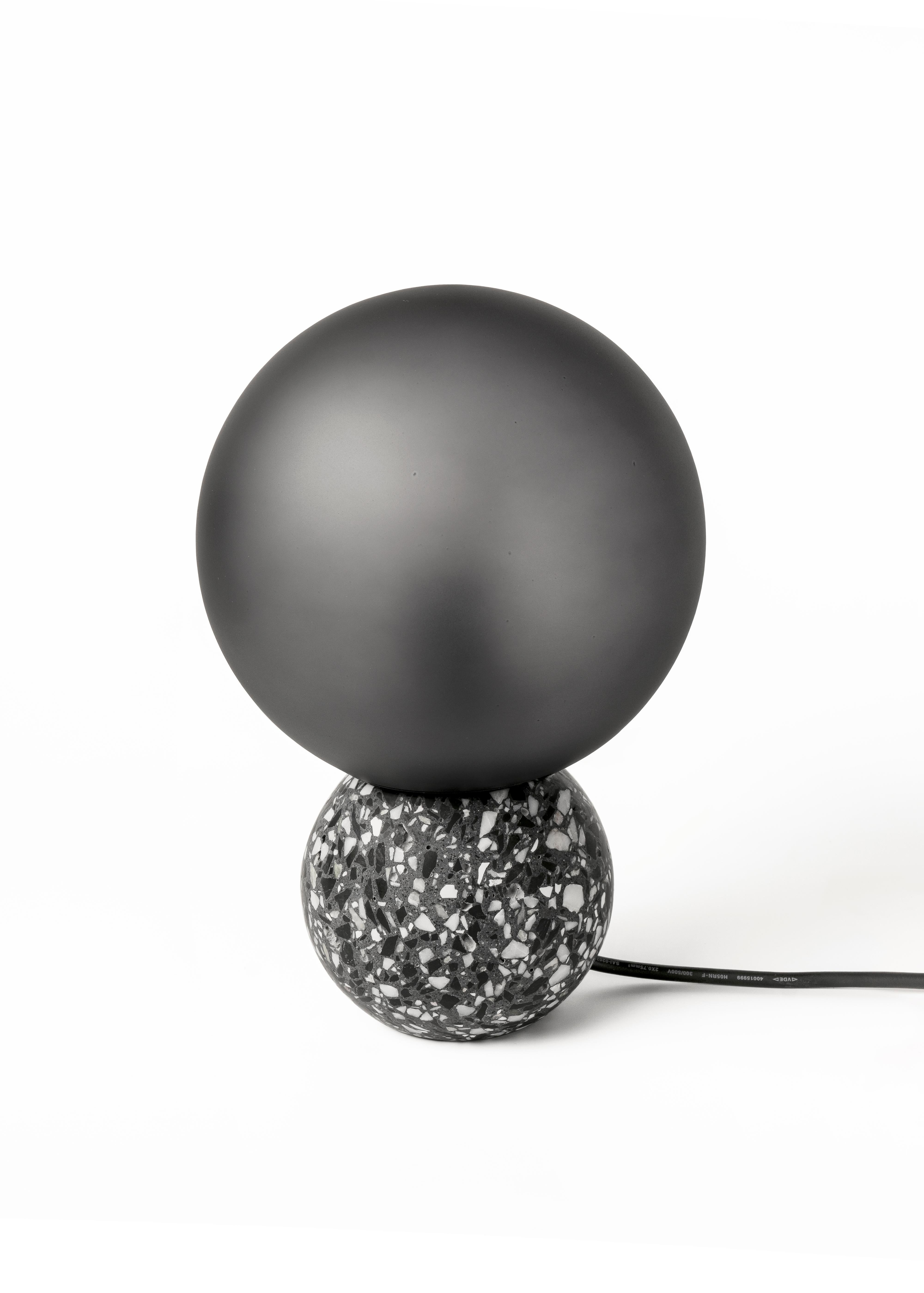 '8' table lamp in terrazzo (Black / white)

Measures: Ø20 cm × H 29.5 cm

Bulb: E27 LED 3W 100-240V 80Ra 200LM 3000K - Comptable with US electric system.

Bentu Design furniture and lightings derive its uniqueness from the simplicity of its forms
